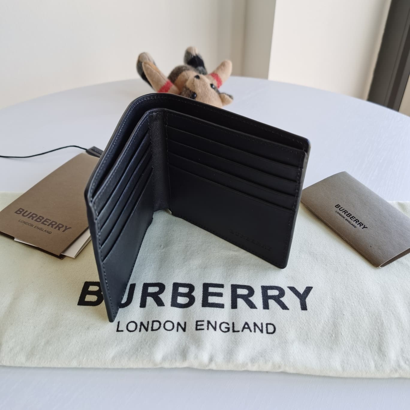 C155 Original model, Burberry Classic Men’s short wallet with two-fold opening. Such a short wallet is really practical and essential for every man! Simple yet stylish, the smoke-colored PVC and cowhide material are used for this product; the solid-colore — image 3