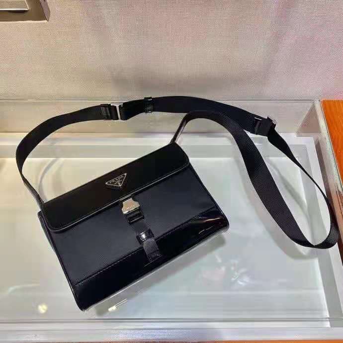C7010 🎉 New postal courier bag 🎉 2VD044 is available now 👏👏 This shoulder bag is made of Re-Nylon, a recycled nylon material, with leather details, offering a modern and stylish design. ECONYL® is a type of recycled nylon yarn produced from purified ocean — image 2