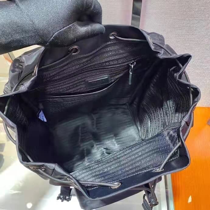 C7025 🎉 Environmental Protection Collection🎉2VZ135🎉🎉 This backpack is made from innovative recycled nylon material, featuring a classic design. It comes with a flap with straps and buttons, as well as four external zipper pockets. The back panel features  — image 8