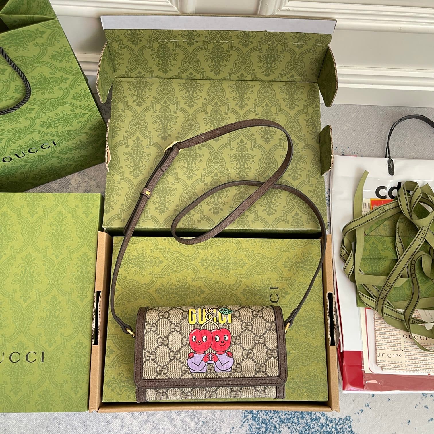 C4067 ‼️The Gucci cherry print mini handbag features designs created by Chilean cartoonist and illustrator Pablo Delcielo. This fashion collection, “Gucci’s Love March,” adds a playful touch of charm. Vibrant mysterious creatures and funky fruit character — image 6