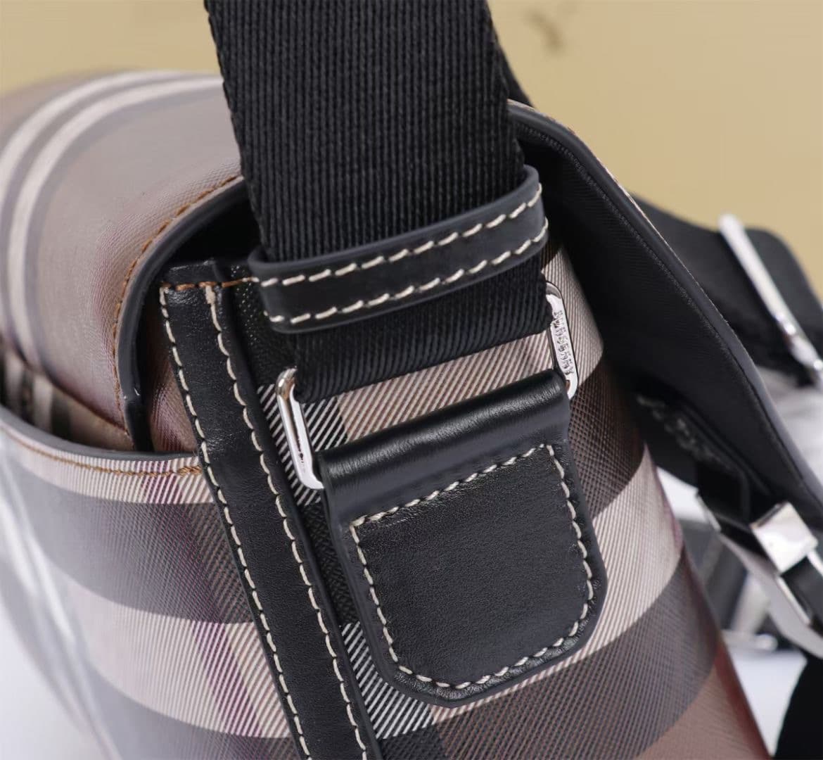 C142 The Balmain messenger bag features a structured design, with a brand’s charcoal-gray pattern. It is decorated with smooth leather details and an emblem design. There is a zipper pocket for storing small items. The adjustable shoulder strap ensures a  — image 6