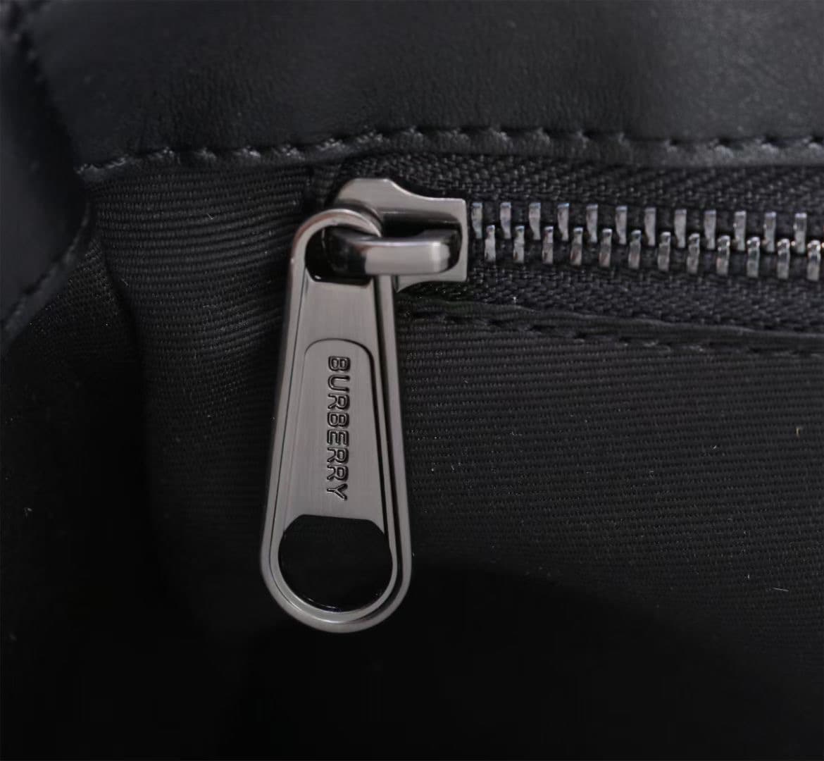 C141 The Balmain messenger bag features a structured design, with a brand’s charcoal-gray pattern. It is adorned with smooth leather details and a logo design. There are zipper pockets for storing small items. The adjustable shoulder strap contributes to  — image 8