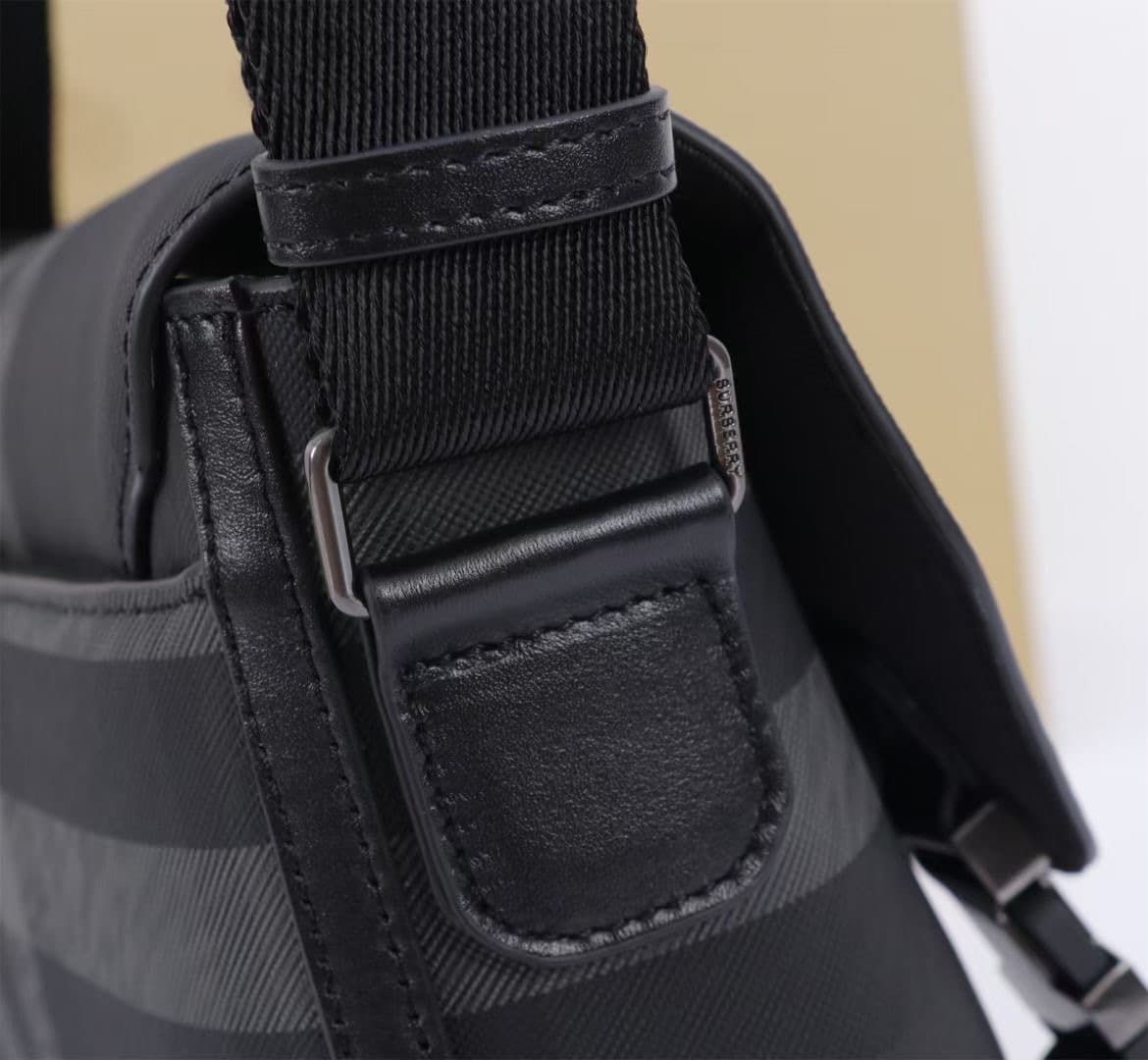 C141 The Balmain messenger bag features a structured design, with a brand’s charcoal-gray pattern. It is adorned with smooth leather details and a logo design. There are zipper pockets for storing small items. The adjustable shoulder strap contributes to  — image 6