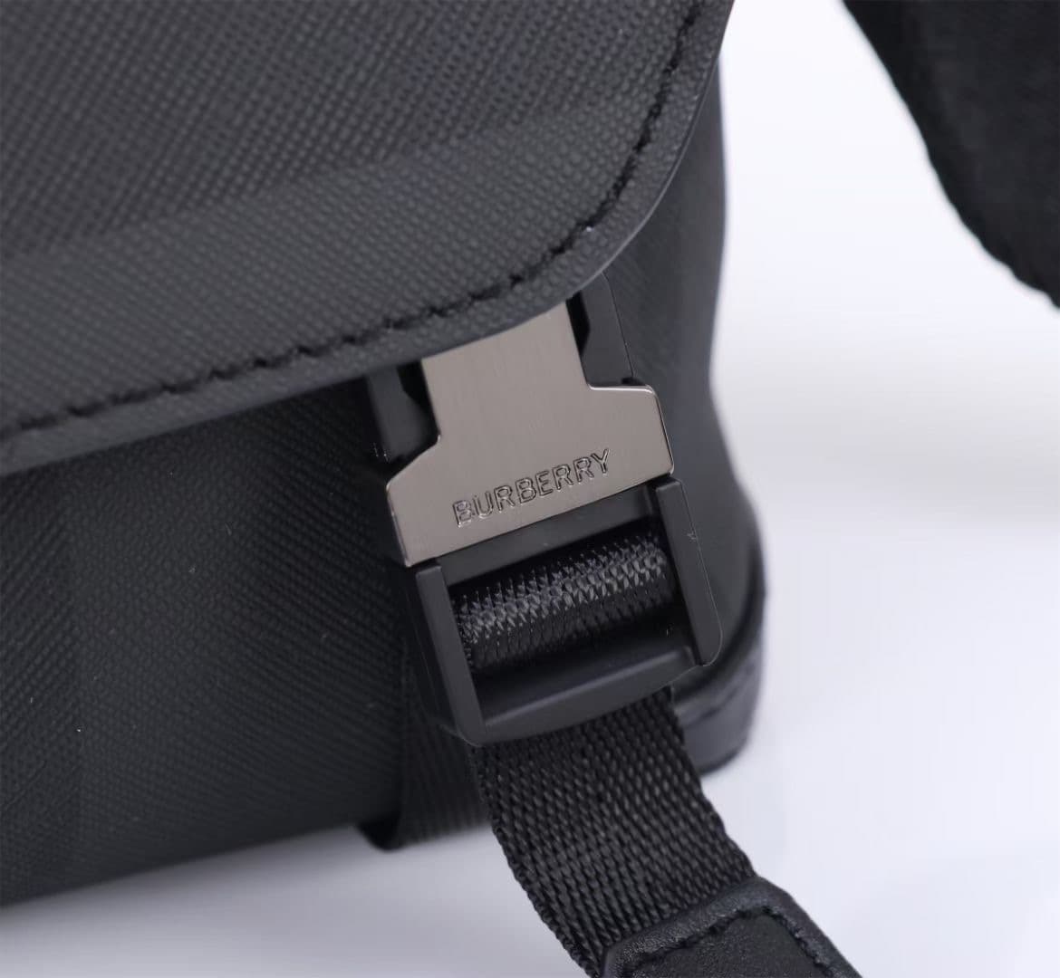 C141 The Balmain messenger bag features a structured design, with a brand’s charcoal-gray pattern. It is adorned with smooth leather details and a logo design. There are zipper pockets for storing small items. The adjustable shoulder strap contributes to  — image 4
