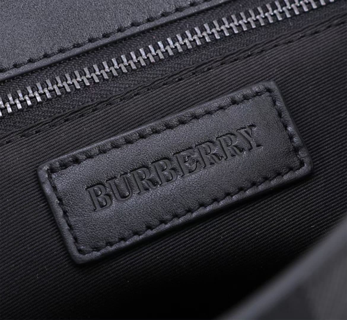 C141 The Balmain messenger bag features a structured design, with a brand’s charcoal-gray pattern. It is adorned with smooth leather details and a logo design. There are zipper pockets for storing small items. The adjustable shoulder strap contributes to  — image 7