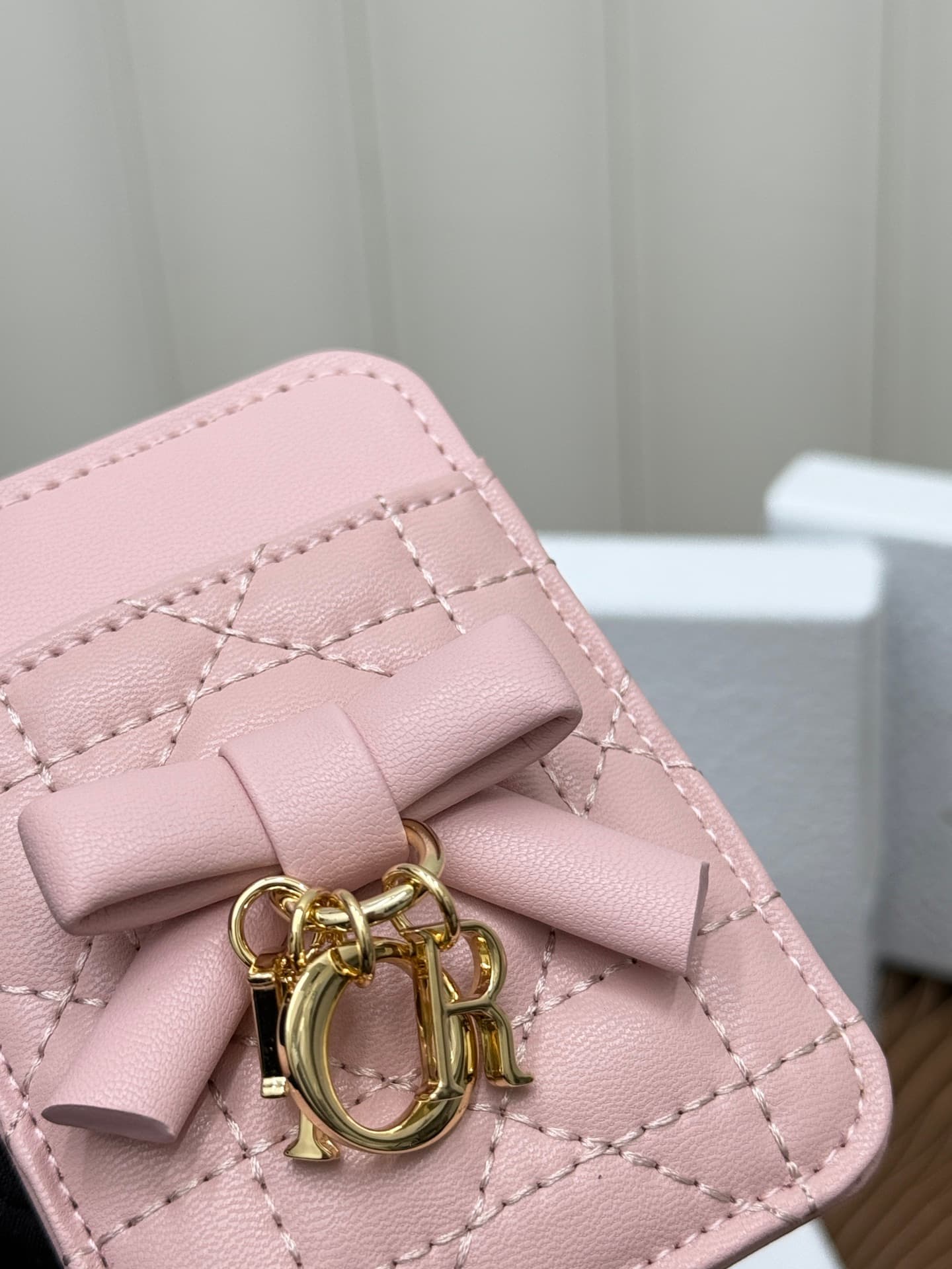 C389 This Lady Dior magnet card case is a delicate accessory that showcases the brand’s exquisite craftsmanship. The Cannage pattern in the lace style, along with the leather details, and the intricate bow ties represent new elements of Dior’s logo, highl — image 5