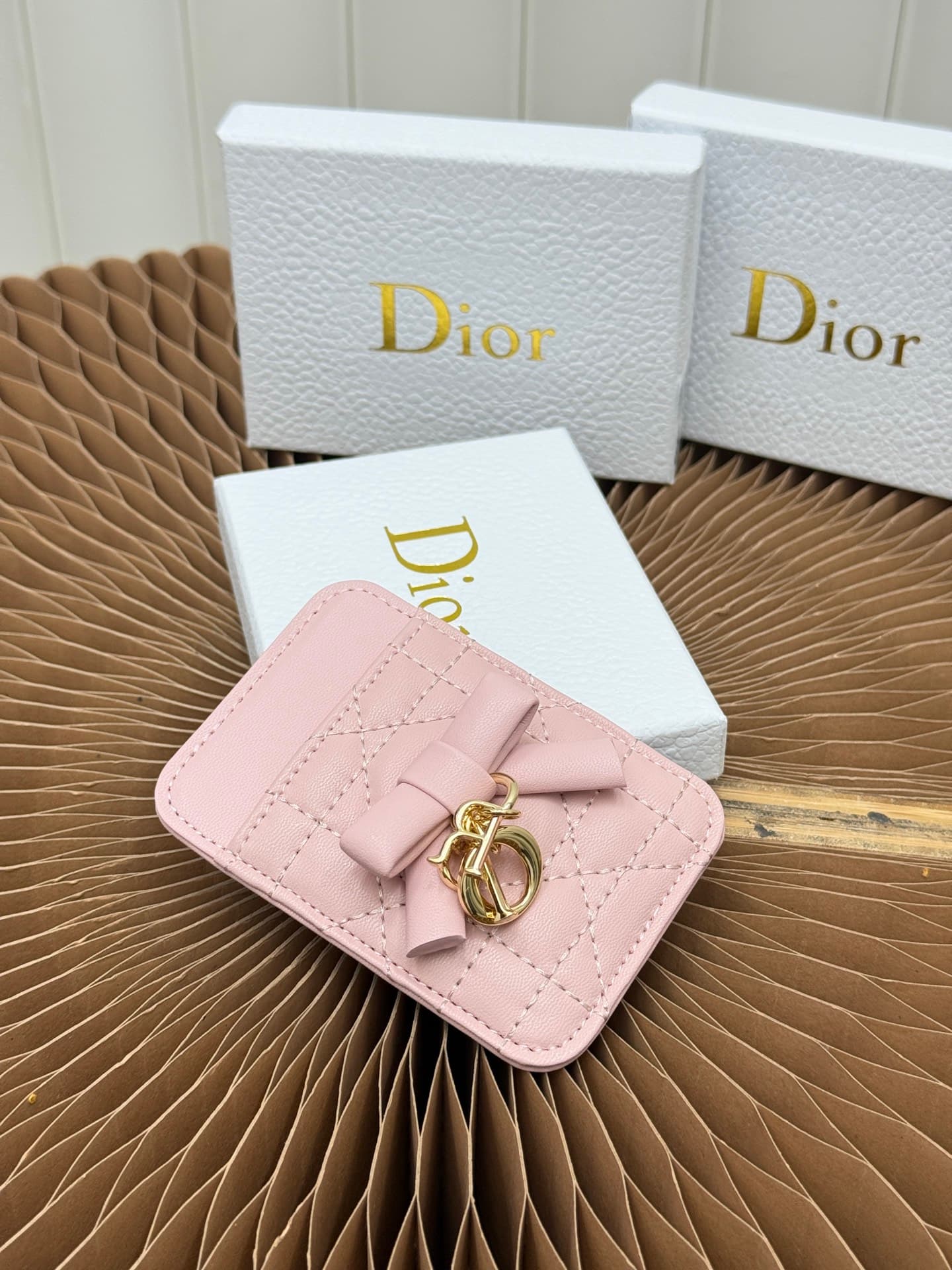 C389 This Lady Dior magnet card case is a delicate accessory that showcases the brand’s exquisite craftsmanship. The Cannage pattern in the lace style, along with the leather details, and the intricate bow ties represent new elements of Dior’s logo, highl — image 2