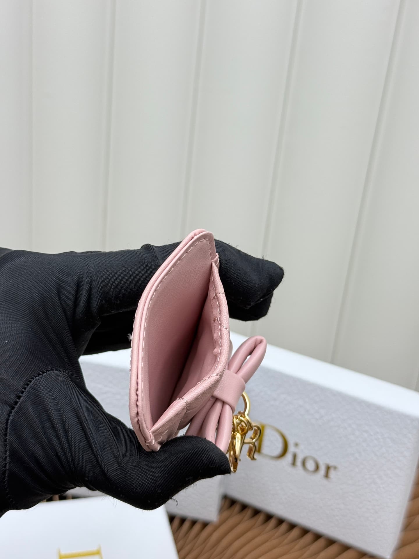 C389 This Lady Dior magnet card case is a delicate accessory that showcases the brand’s exquisite craftsmanship. The Cannage pattern in the lace style, along with the leather details, and the intricate bow ties represent new elements of Dior’s logo, highl — image 7