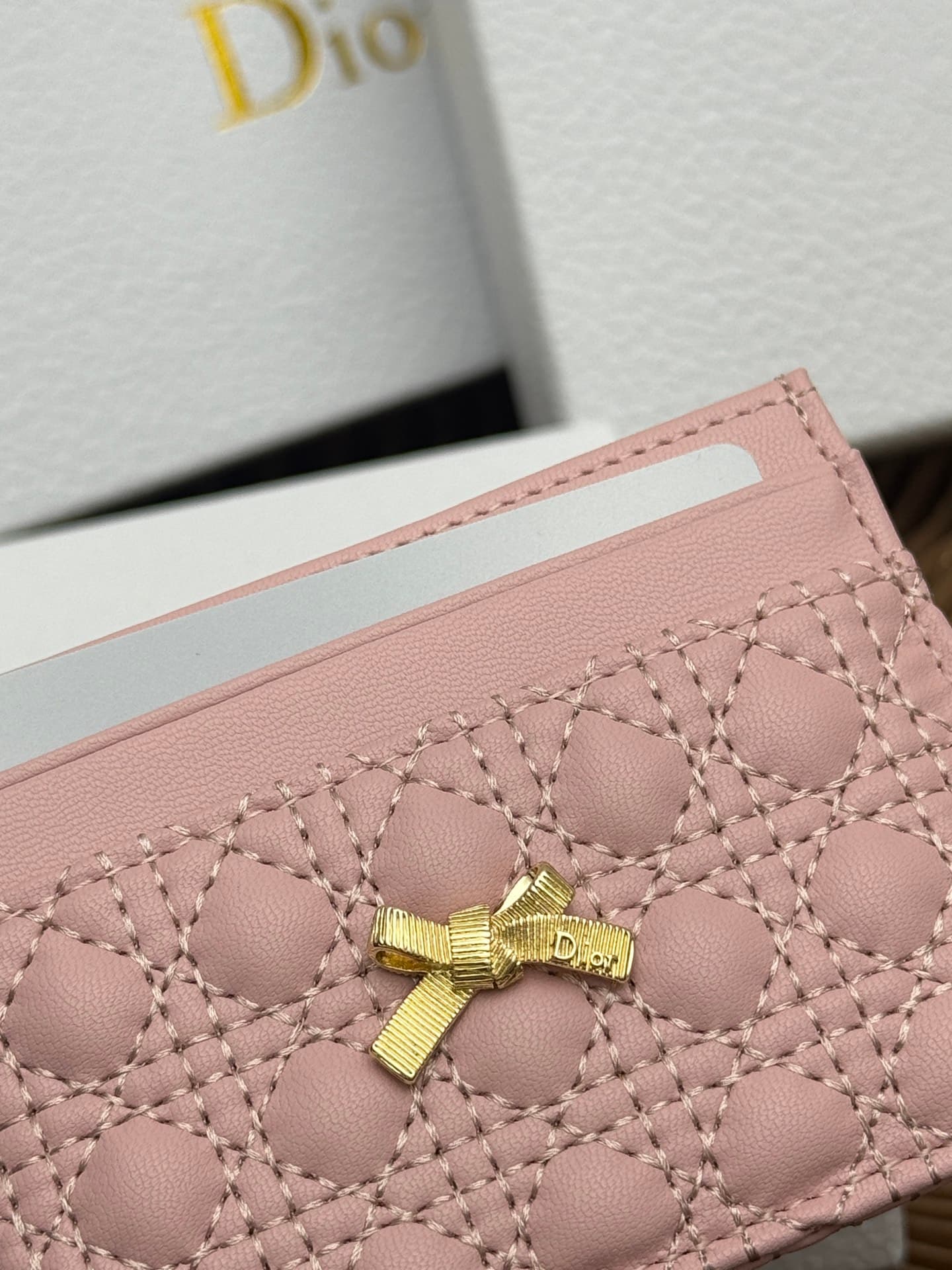 C395 This Baby Bow Freesia card case is designed in a elegant and practical manner. The black mini-check pattern with leather texture, along with delicate bow ties, offers a clever new interpretation of the classic brand’s theme. This exquisite accessory  — image 5