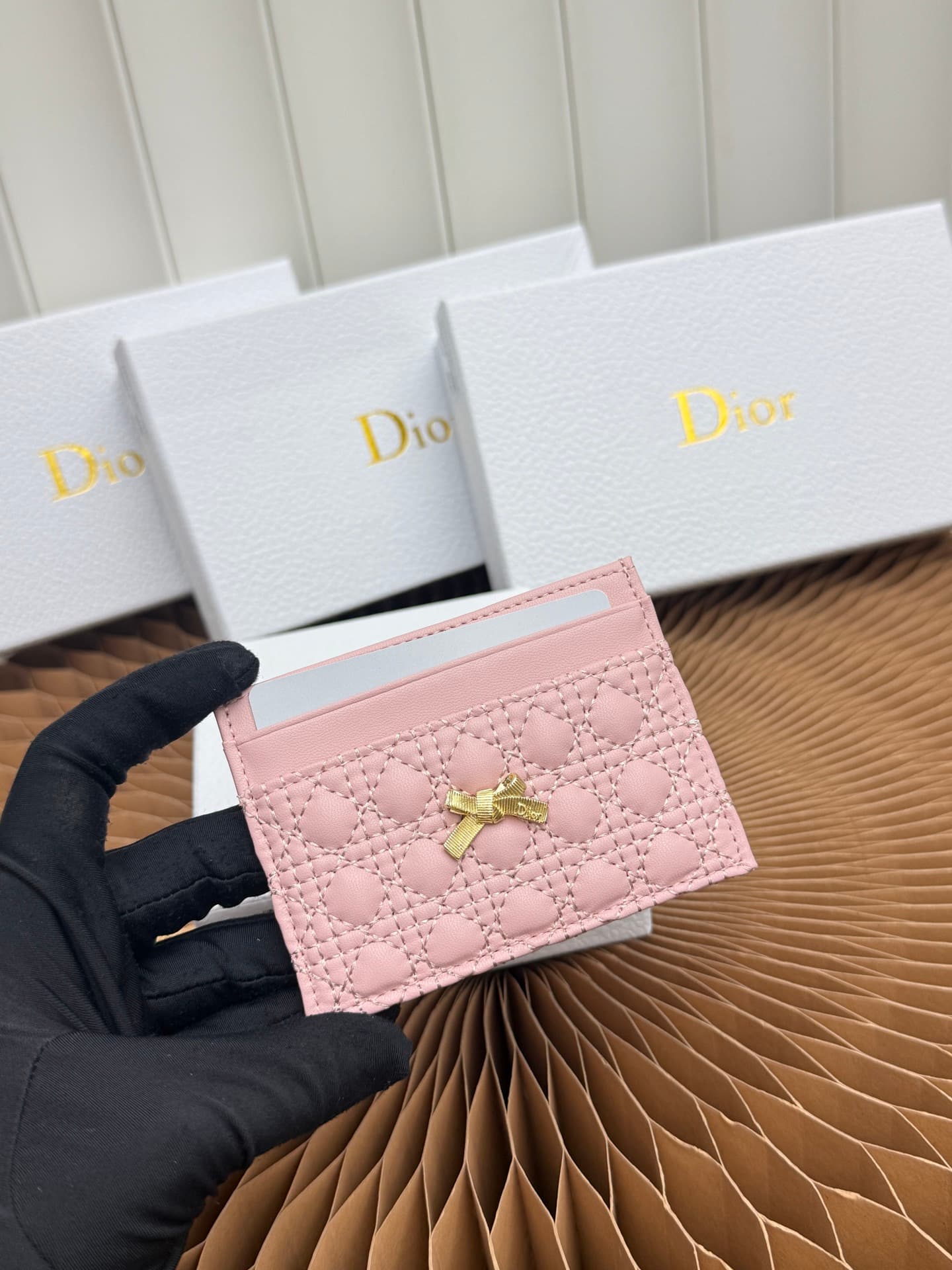 C395 This Baby Bow Freesia card case is designed in a elegant and practical manner. The black mini-check pattern with leather texture, along with delicate bow ties, offers a clever new interpretation of the classic brand’s theme. This exquisite accessory  — image 4