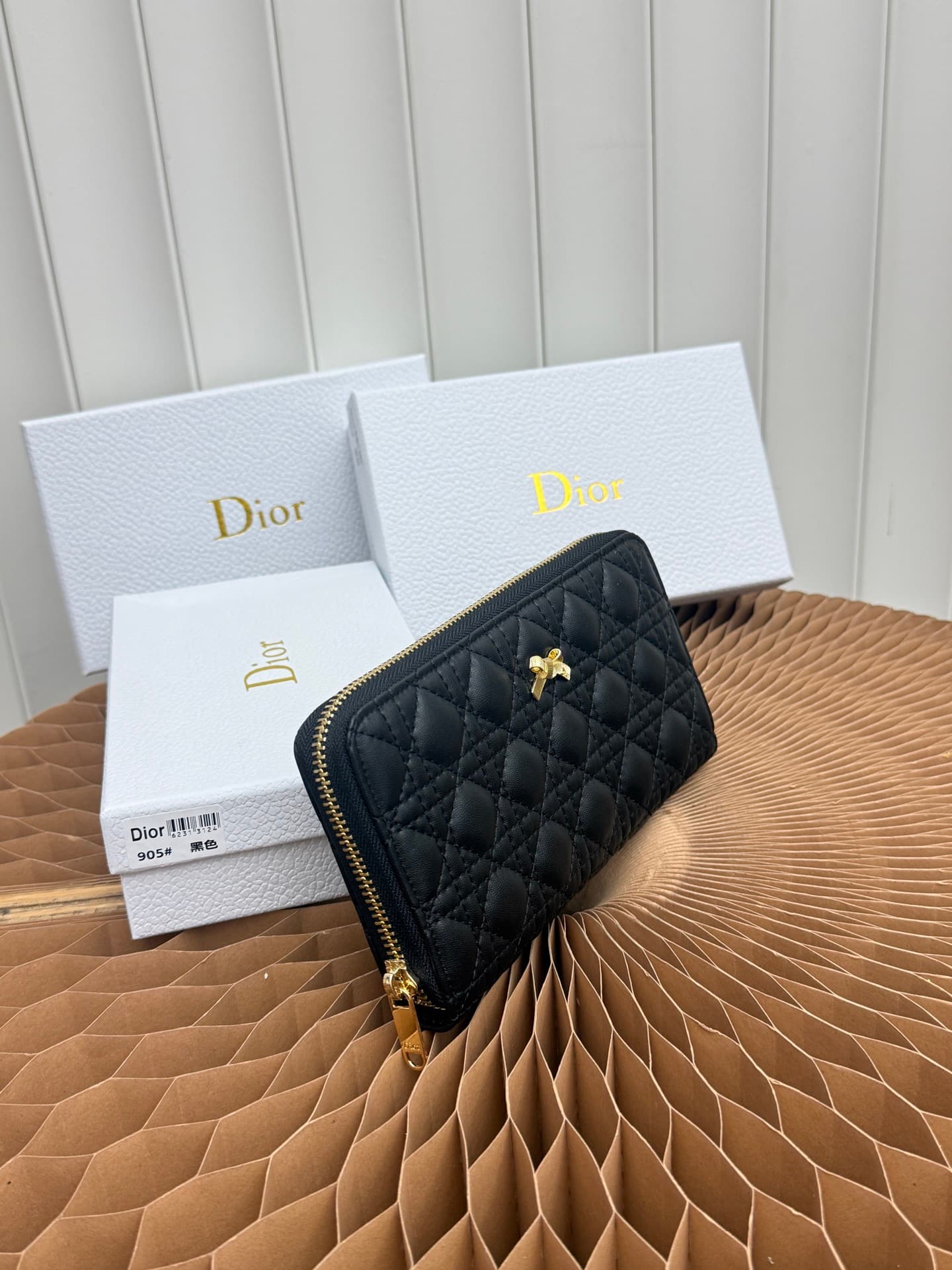 C403 This thin silver wallet from Baby Bow Voyageur is an essential accessory, exuding a simple and elegant style. The black mini boucle pattern on the lamb leather, combined with delicate bow ties, offers a clever new interpretation of the classic brand’ — image 2