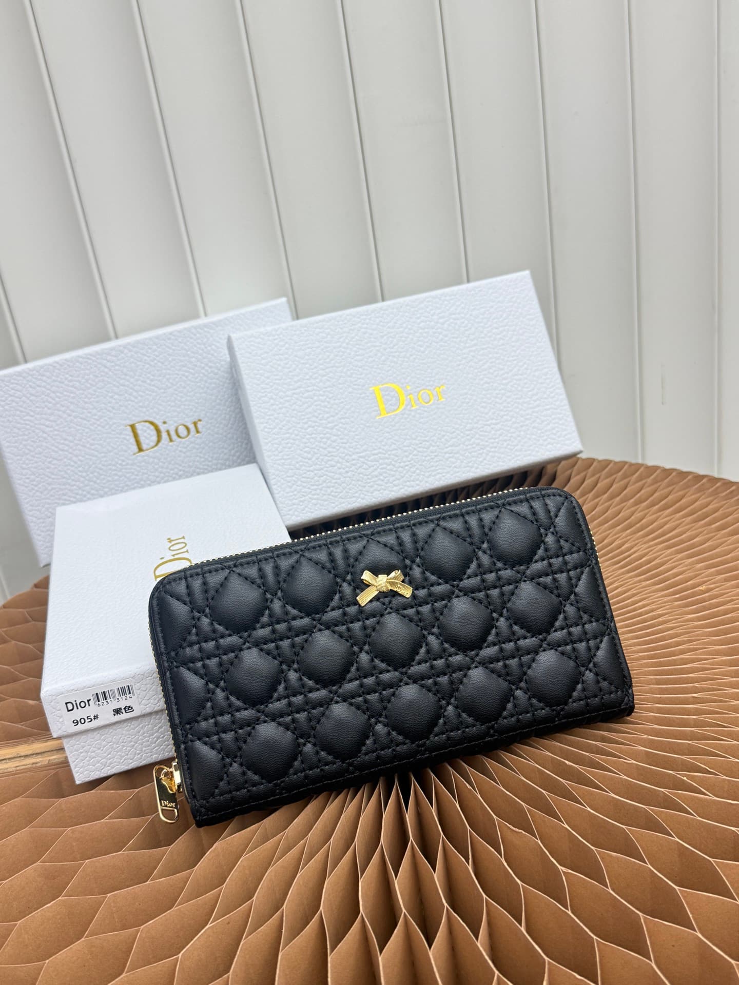 C403 This thin silver wallet from Baby Bow Voyageur is an essential accessory, exuding a simple and elegant style. The black mini boucle pattern on the lamb leather, combined with delicate bow ties, offers a clever new interpretation of the classic brand’ — image 1