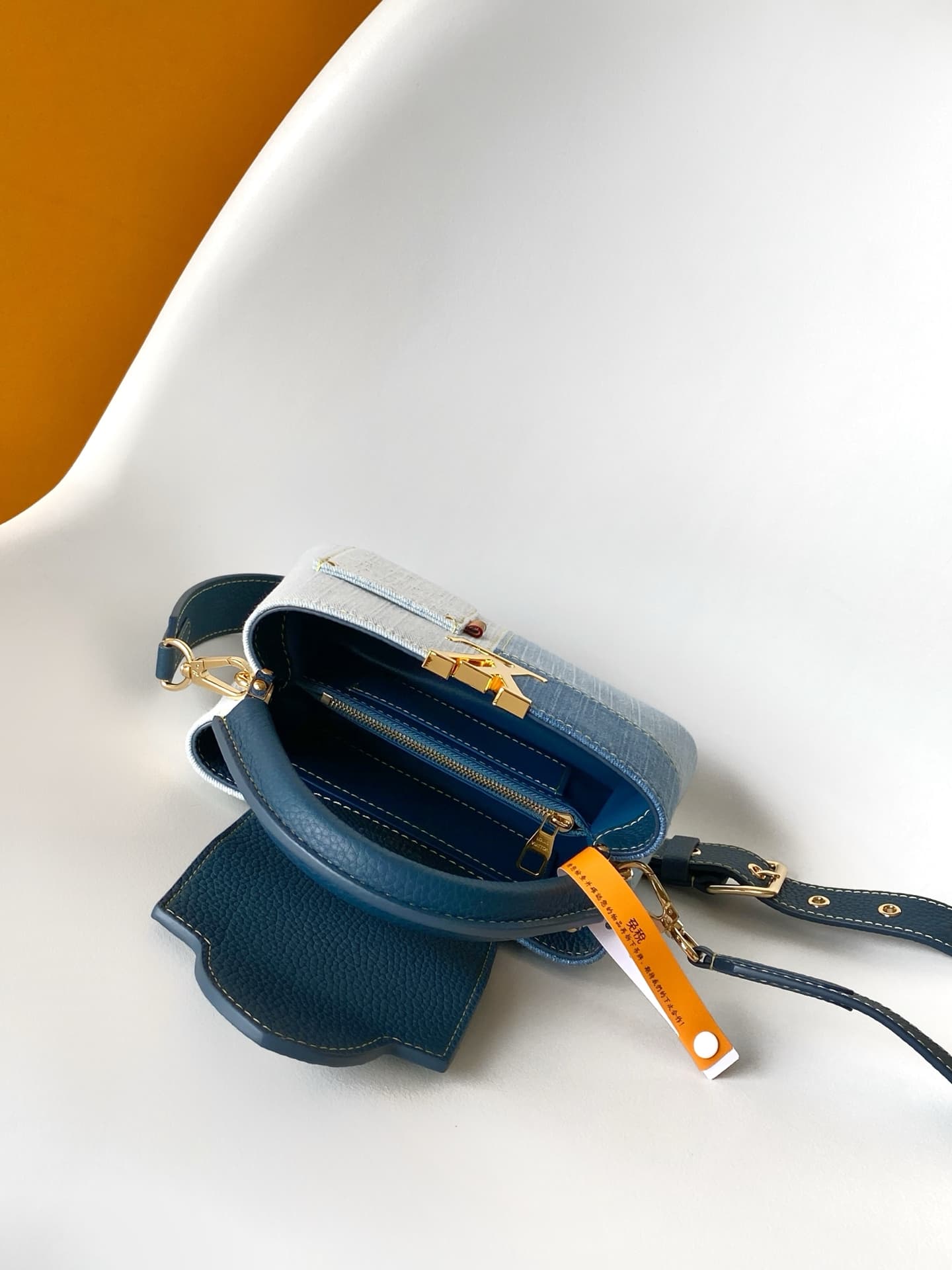 C5265 💰M27302 – Premium original style. The Capucines BB handbag features a denim material, reflecting contemporary fashion trends; its unique color-blocked design is distinctive. The bag comes with Taurillon leather handles, a flip cover, and a detachabl — image 8