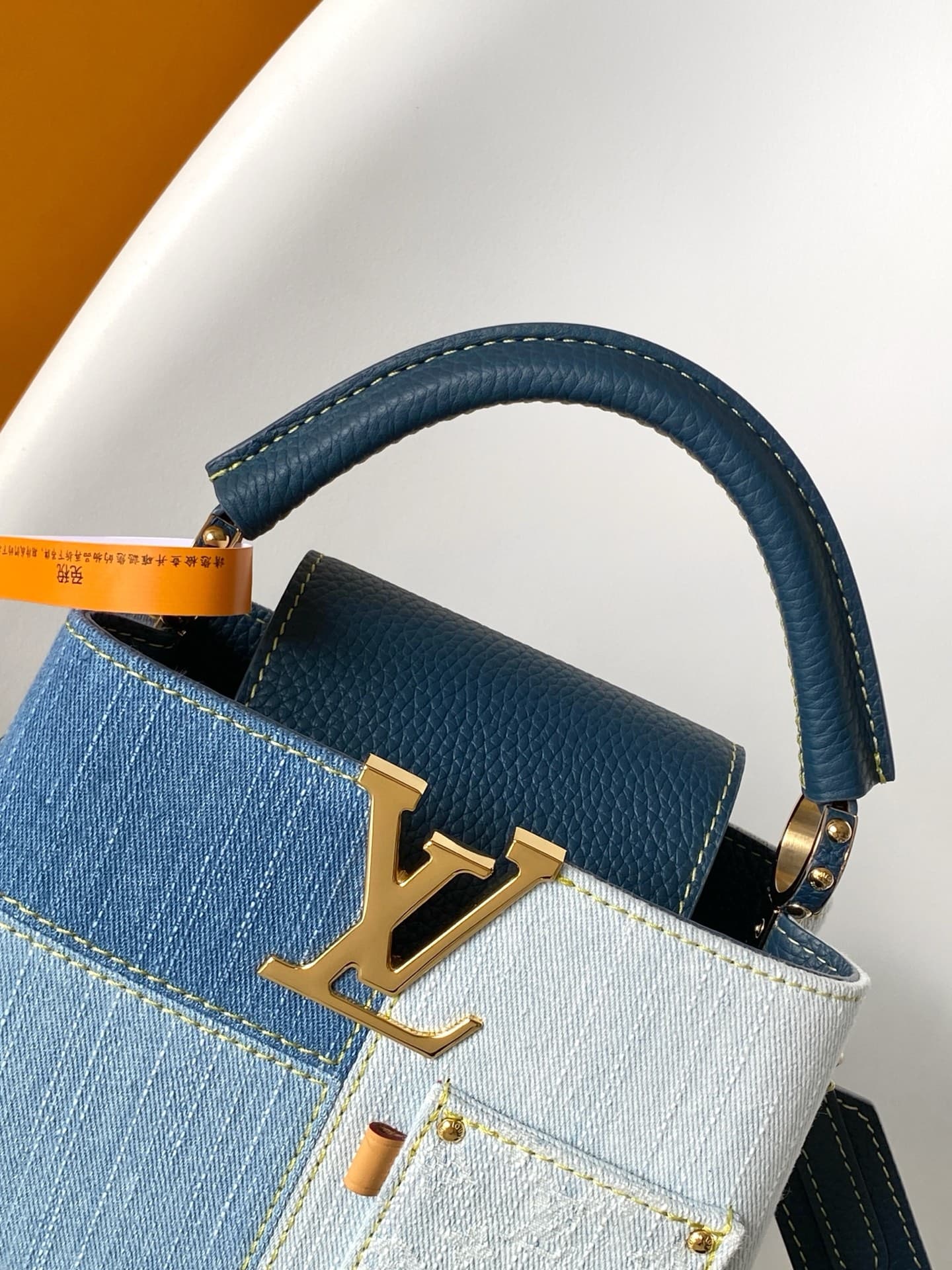 C5265 💰M27302 – Premium original style. The Capucines BB handbag features a denim material, reflecting contemporary fashion trends; its unique color-blocked design is distinctive. The bag comes with Taurillon leather handles, a flip cover, and a detachabl — image 5