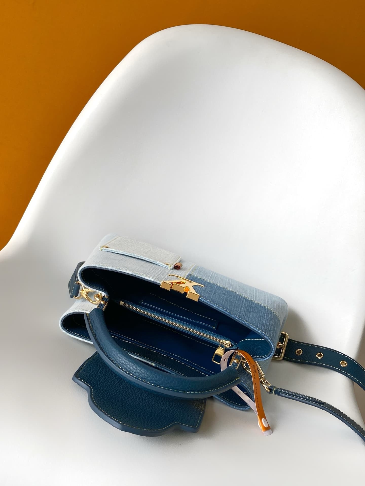 C5264 💰M27302 – Premium original style. The Capucines BB handbag features a denim material, reflecting contemporary fashion trends; its unique color-blocked design is truly distinctive. The bag comes with Taurillon leather handles, a flap closure, and a d — image 8