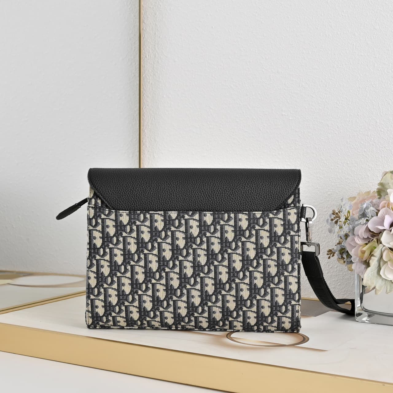C1818 The A5 triangle-handbag is a new flagship product. It is crafted from beige and black Oblique-printed fabric, along with black suede leather with a saddle-shaped flap design. The spacious zipper compartment can hold a phone, and there are also card  — image 3
