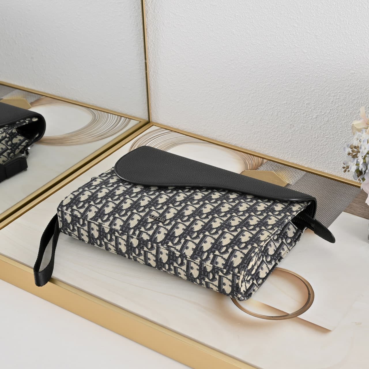 C1818 The A5 triangle-handbag is a new flagship product. It is crafted from beige and black Oblique-printed fabric, along with black suede leather with a saddle-shaped flap design. The spacious zipper compartment can hold a phone, and there are also card  — image 4