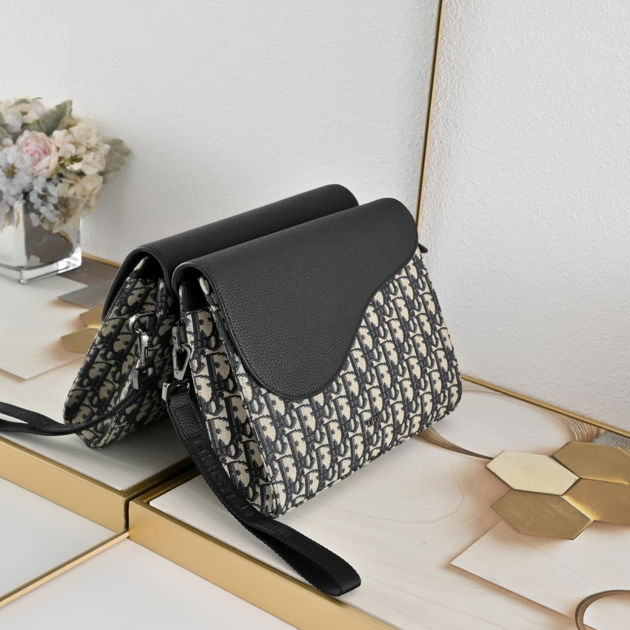 C1818 The A5 triangle-handbag is a new flagship product. It is crafted from beige and black Oblique-printed fabric, along with black suede leather with a saddle-shaped flap design. The spacious zipper compartment can hold a phone, and there are also card  — image 2