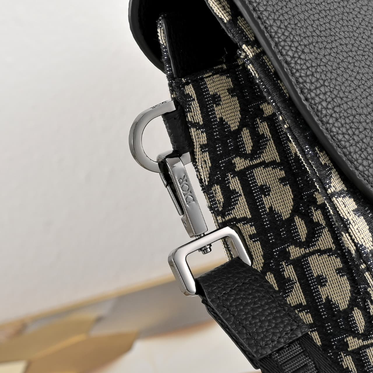 C1818 The A5 triangle-handbag is a new flagship product. It is crafted from beige and black Oblique-printed fabric, along with black suede leather with a saddle-shaped flap design. The spacious zipper compartment can hold a phone, and there are also card  — image 6