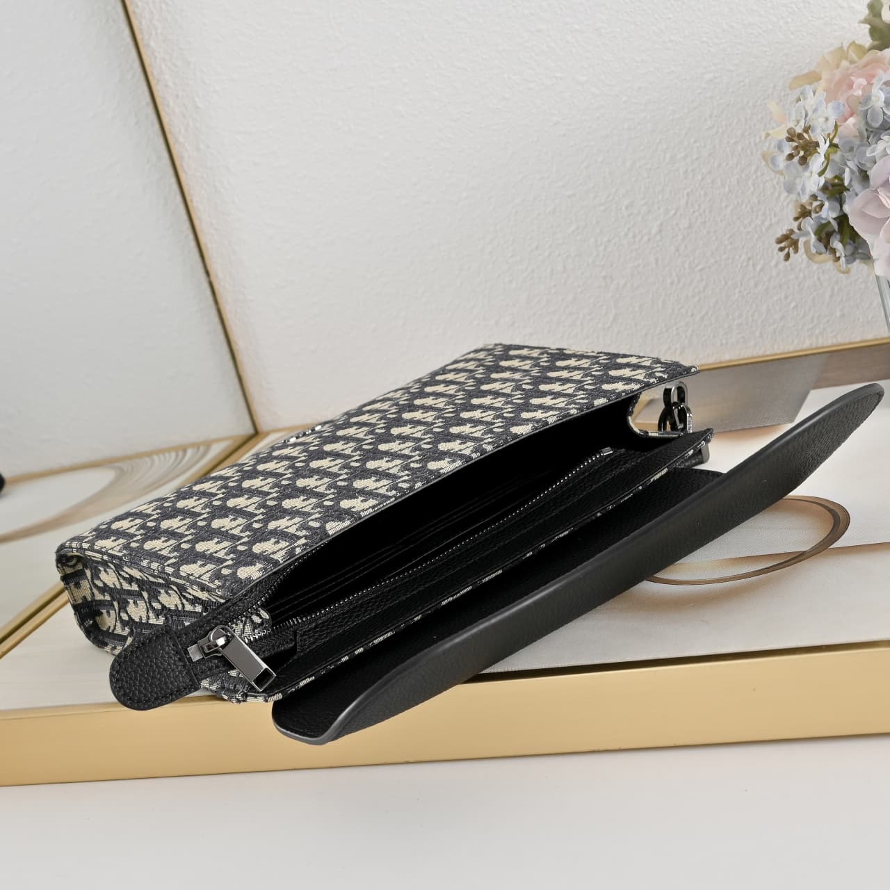C1818 The A5 triangle-handbag is a new flagship product. It is crafted from beige and black Oblique-printed fabric, along with black suede leather with a saddle-shaped flap design. The spacious zipper compartment can hold a phone, and there are also card  — image 8