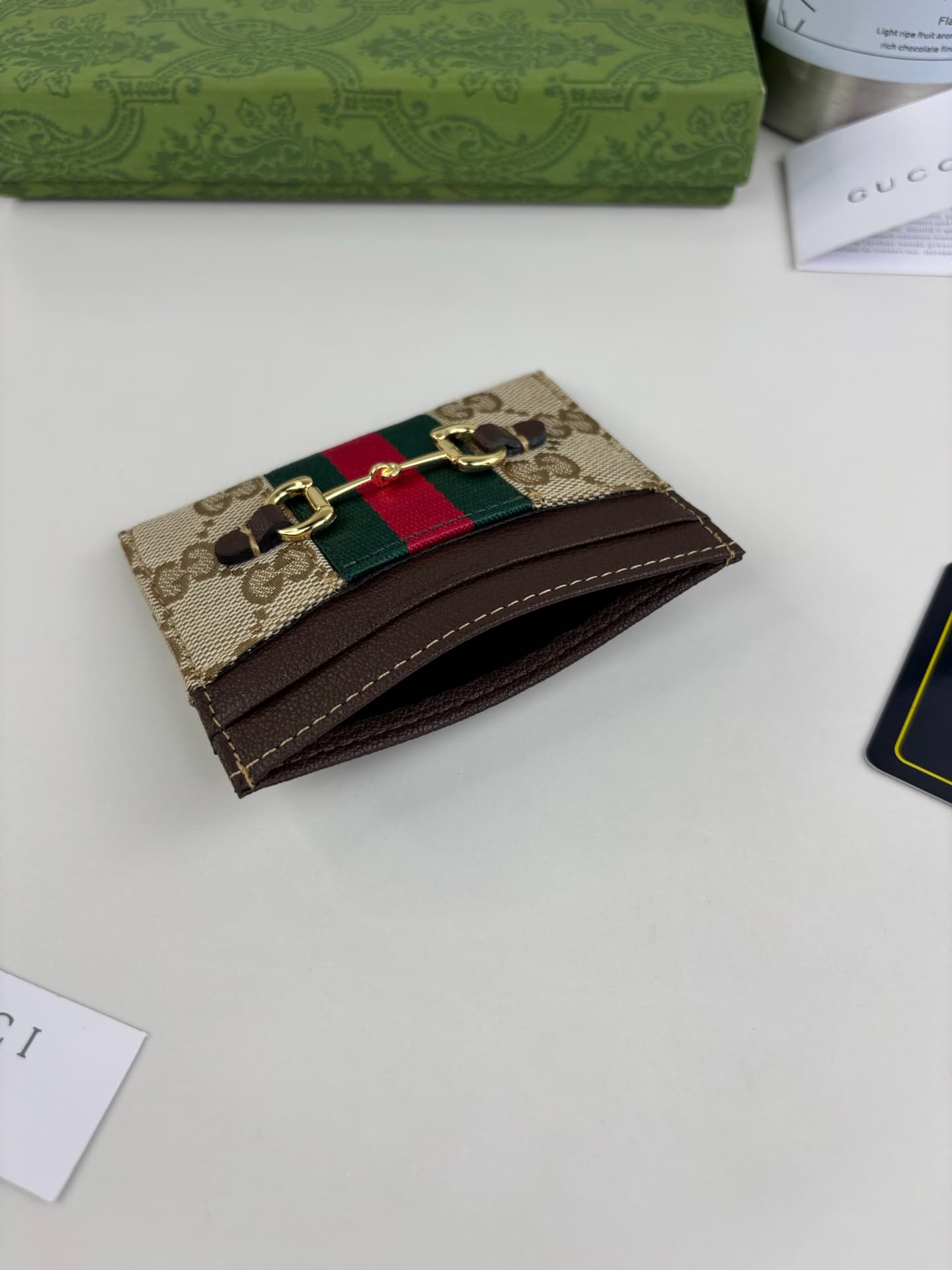 C3968 The Gucci Generation collection deeply explores the brand’s heritage elements, blending designs from different generations into a cohesive aesthetic narrative. The small accessories feature a tribute to the buckle design, integrating iconic details  — image 3