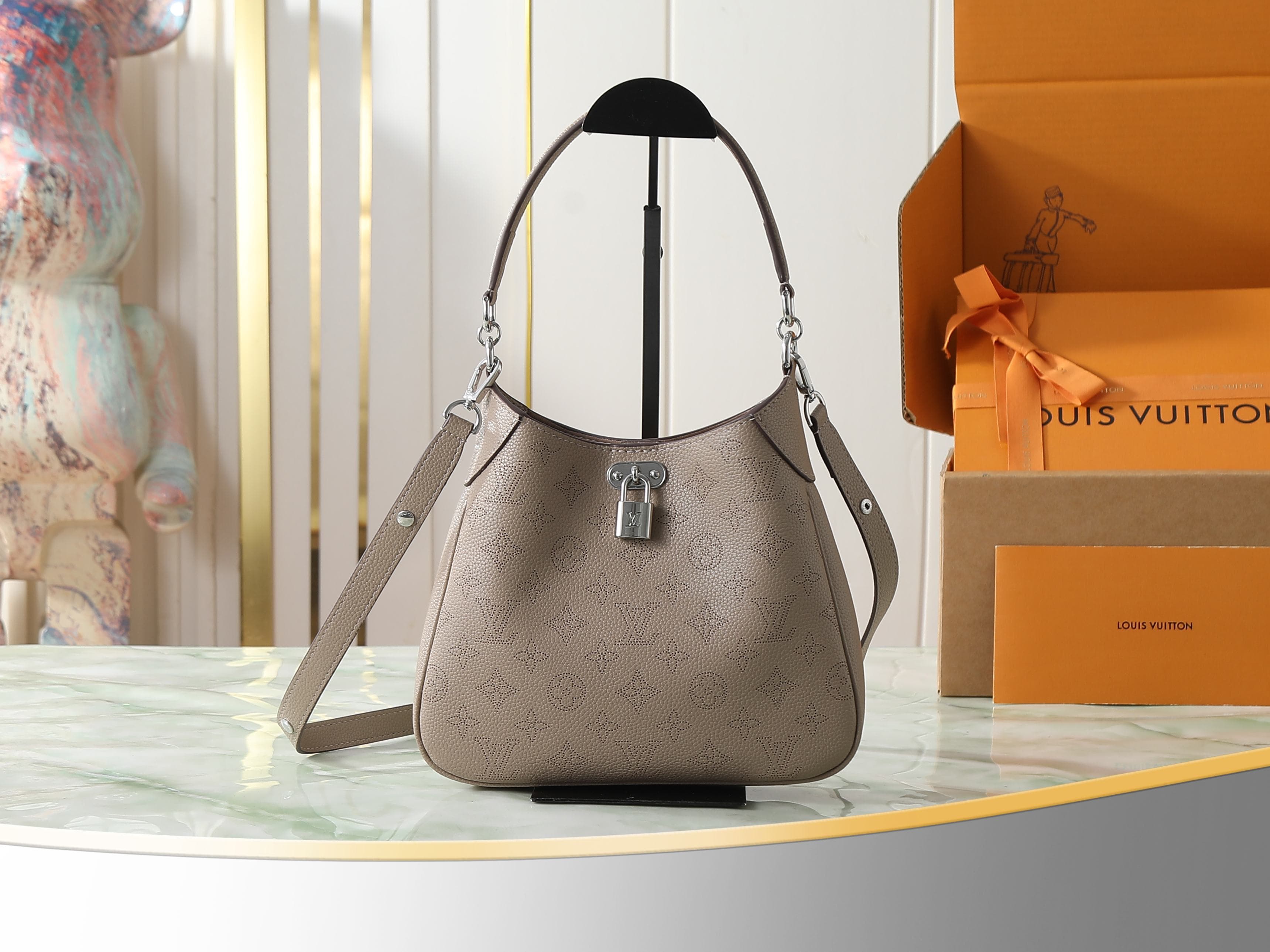C5183 [Top-quality original items, exclusive real photos] M27336 gray-brown; M27459 all leather perforated crossbody bag, small size; m27336 gray-brown; m28306 black; m27459 beige. This small-sized crossbody bag from the Mahina collection features elegant — image 1