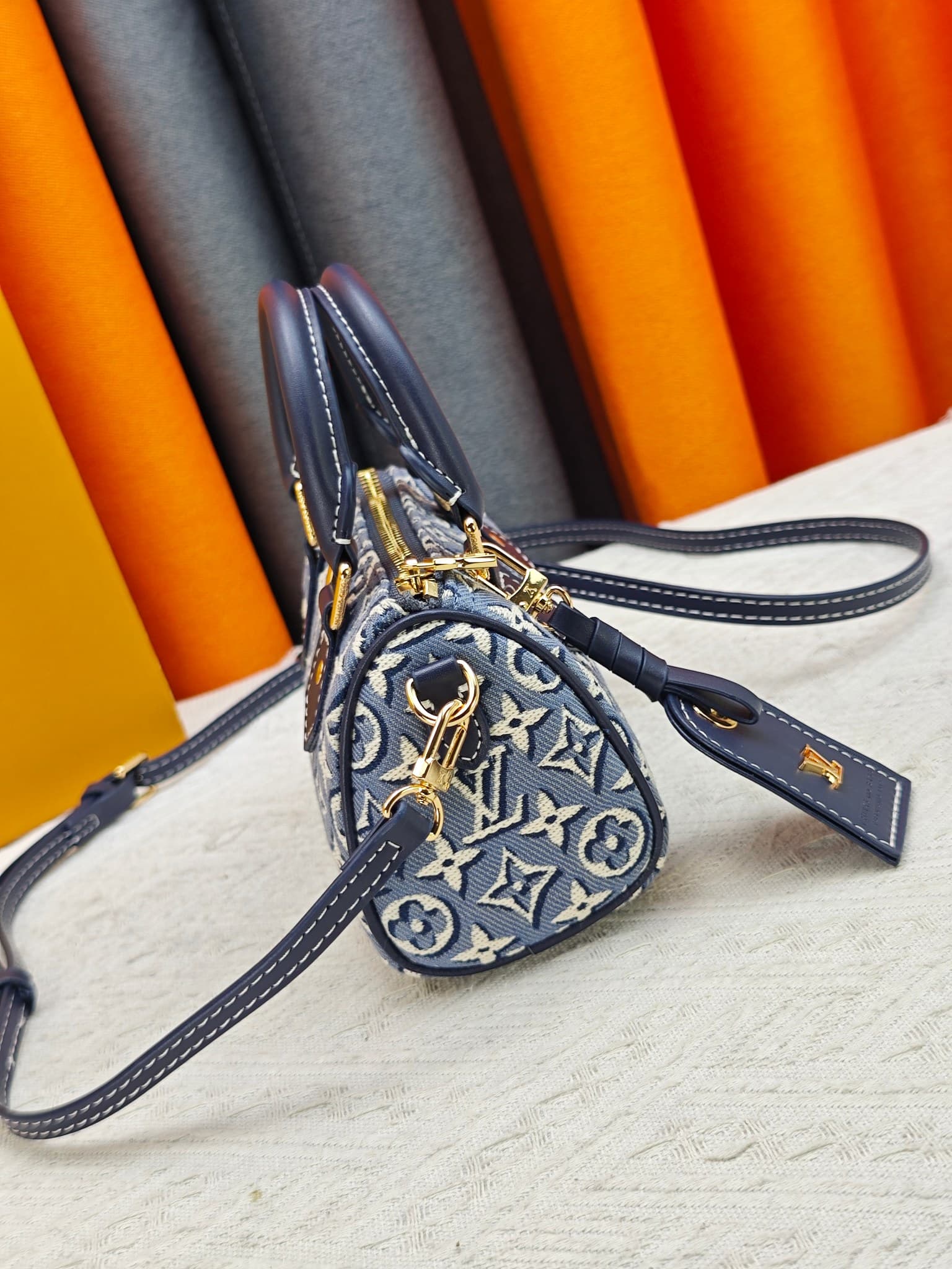 C5055 M28502  2A187  M81085 Batik. This Nano Speedy handbag features a delicate batik canvas design adorned with the Monogram Emblème logo. The bag’s body is styled in the traditional hard shell colors of the brand, and it comes with contrasting leather t — image 3