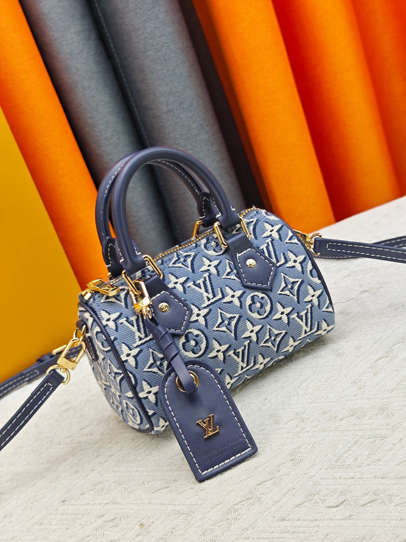 C5055 M28502  2A187  M81085 Batik. This Nano Speedy handbag features a delicate batik canvas design adorned with the Monogram Emblème logo. The bag’s body is styled in the traditional hard shell colors of the brand, and it comes with contrasting leather t — image 2