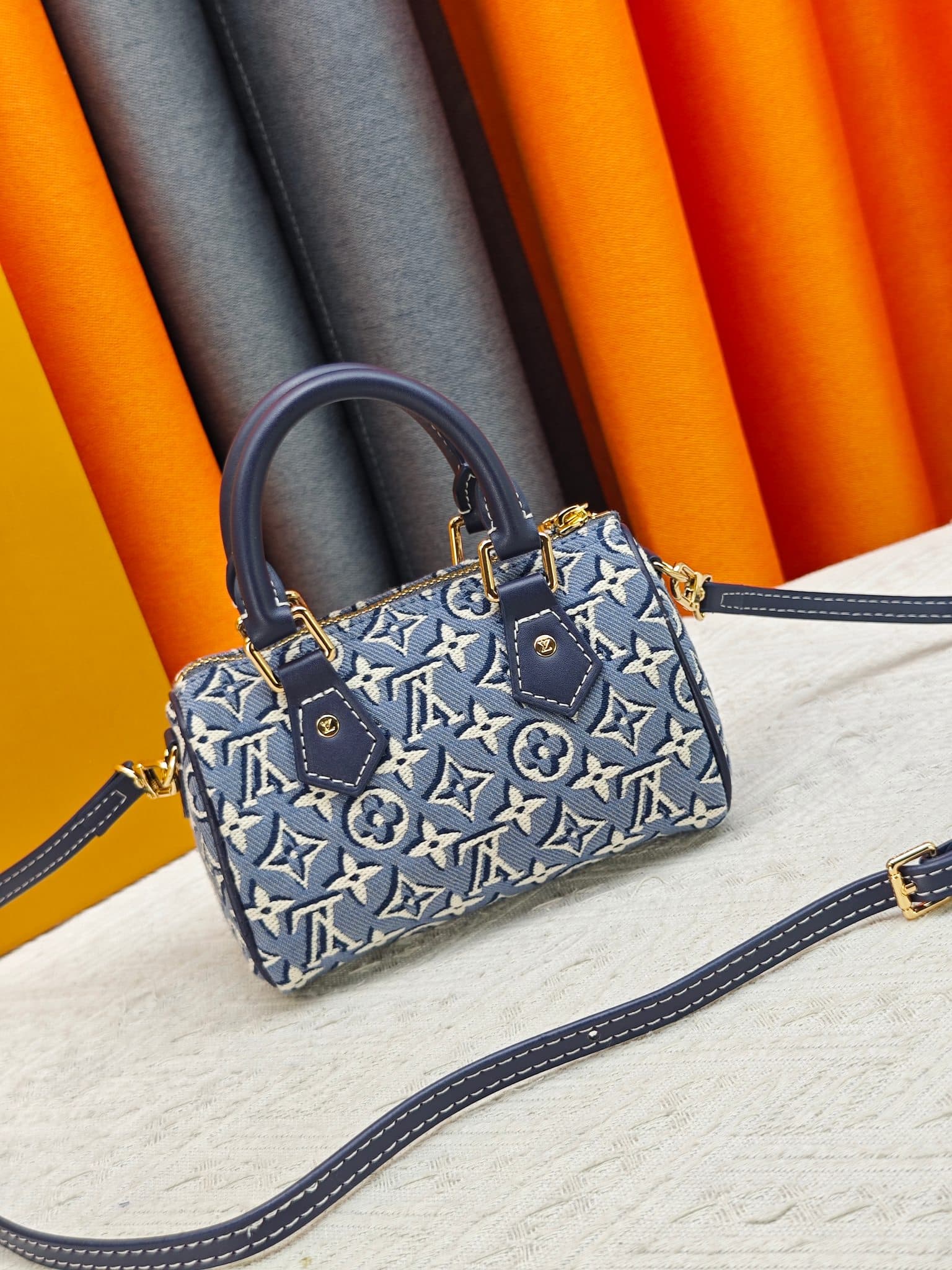 C5055 M28502  2A187  M81085 Batik. This Nano Speedy handbag features a delicate batik canvas design adorned with the Monogram Emblème logo. The bag’s body is styled in the traditional hard shell colors of the brand, and it comes with contrasting leather t — image 4
