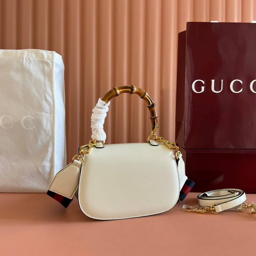 C4001 🔥🔥 The bamboo motifs symbolize Gucci’s enduring design heritage. The bamboo handles on this handbag are shaped through the heat of flames. This craftsmanship originated among Florentine artisans after World War II. The bag is made of green leather,  — image 2