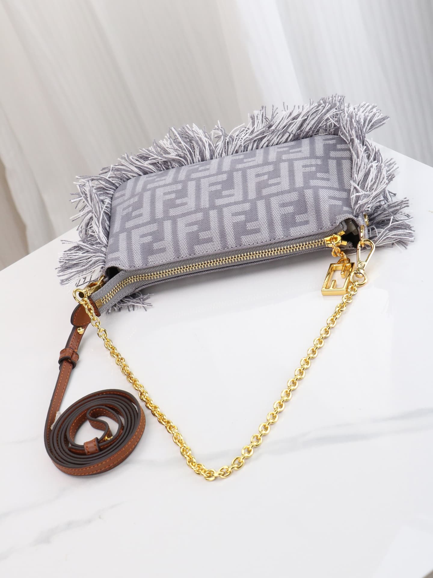 C2860 Model 7717 Baguette handbag. Made of denim print material, with classic double F logos. Features detachable thin chains and long shoulder straps. Closes with zippers, and the zipper pulls have the distinctive FF pattern. It’s compact and elegant; pe — image 8