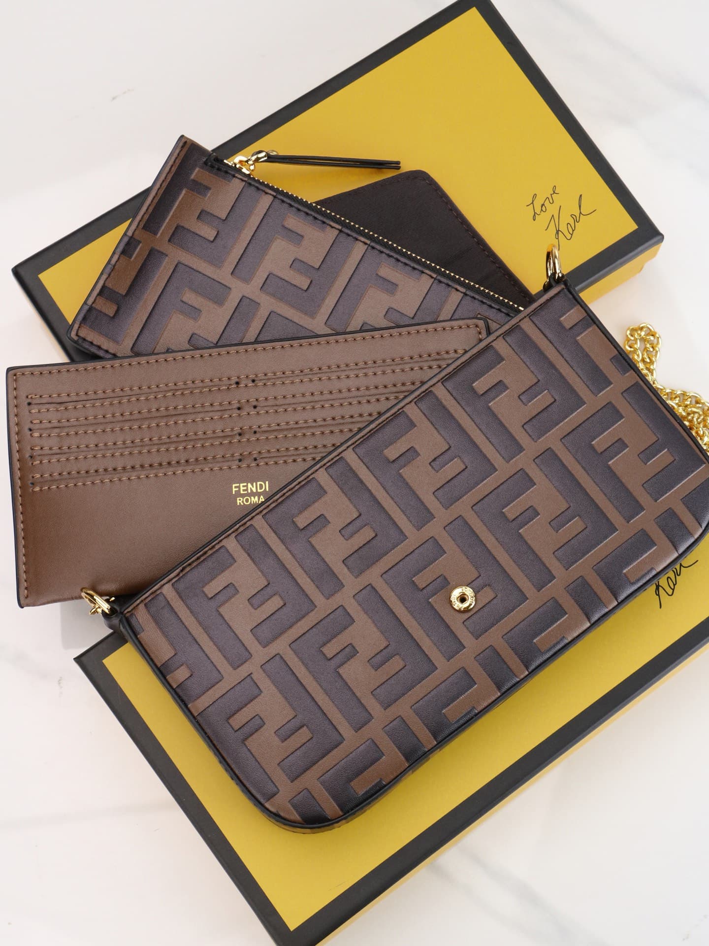 C2870 Fendi mini handbag with geometric patterns, featuring a flap closure and zipper opening. It has a detachable chain strap. The interior is equipped with flat pockets. The bag’s exterior is made of distinctive brown leather with black raised FF prints — image 6