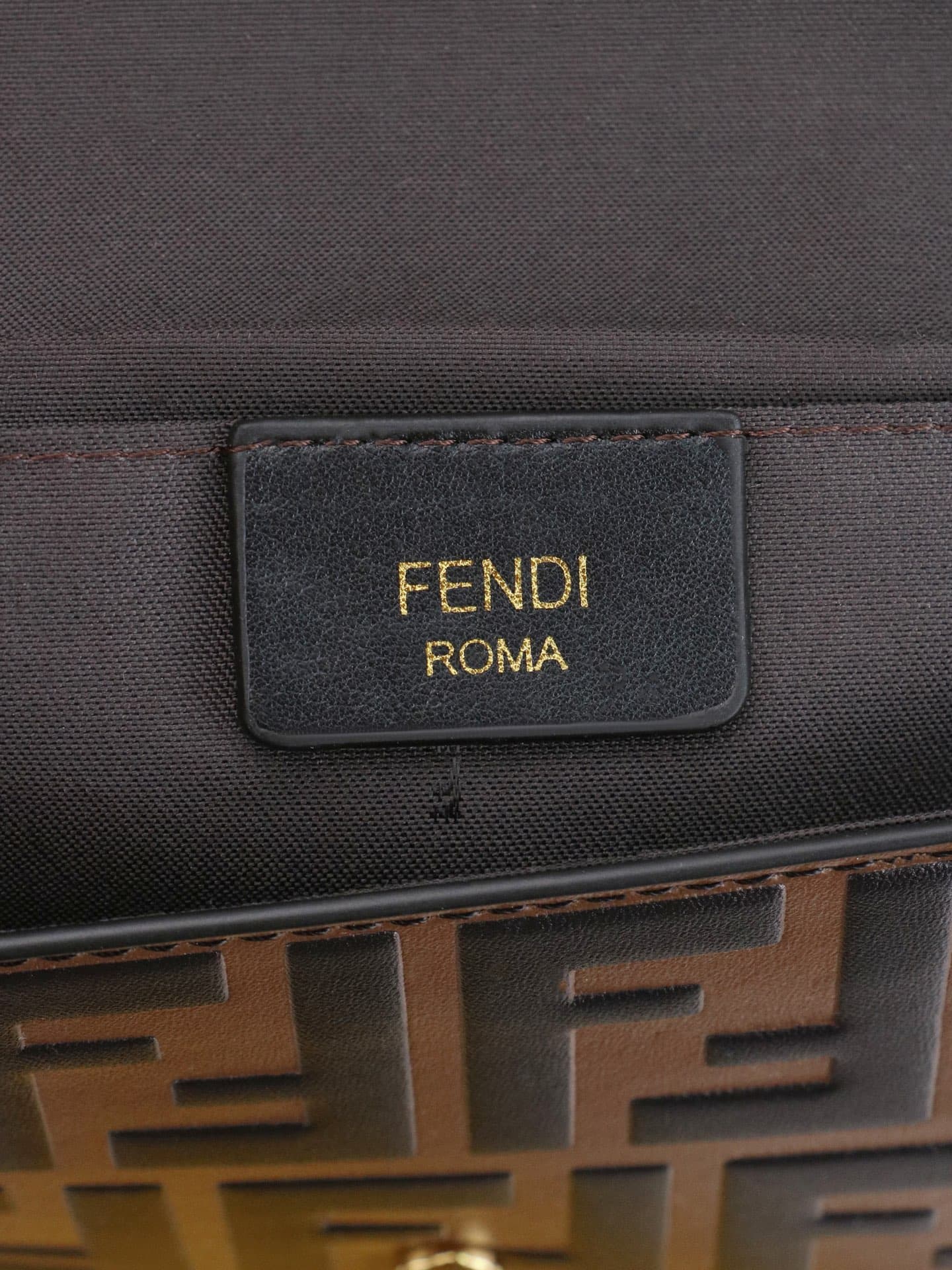 C2870 Fendi mini handbag with geometric patterns, featuring a flap closure and zipper opening. It has a detachable chain strap. The interior is equipped with flat pockets. The bag’s exterior is made of distinctive brown leather with black raised FF prints — image 8
