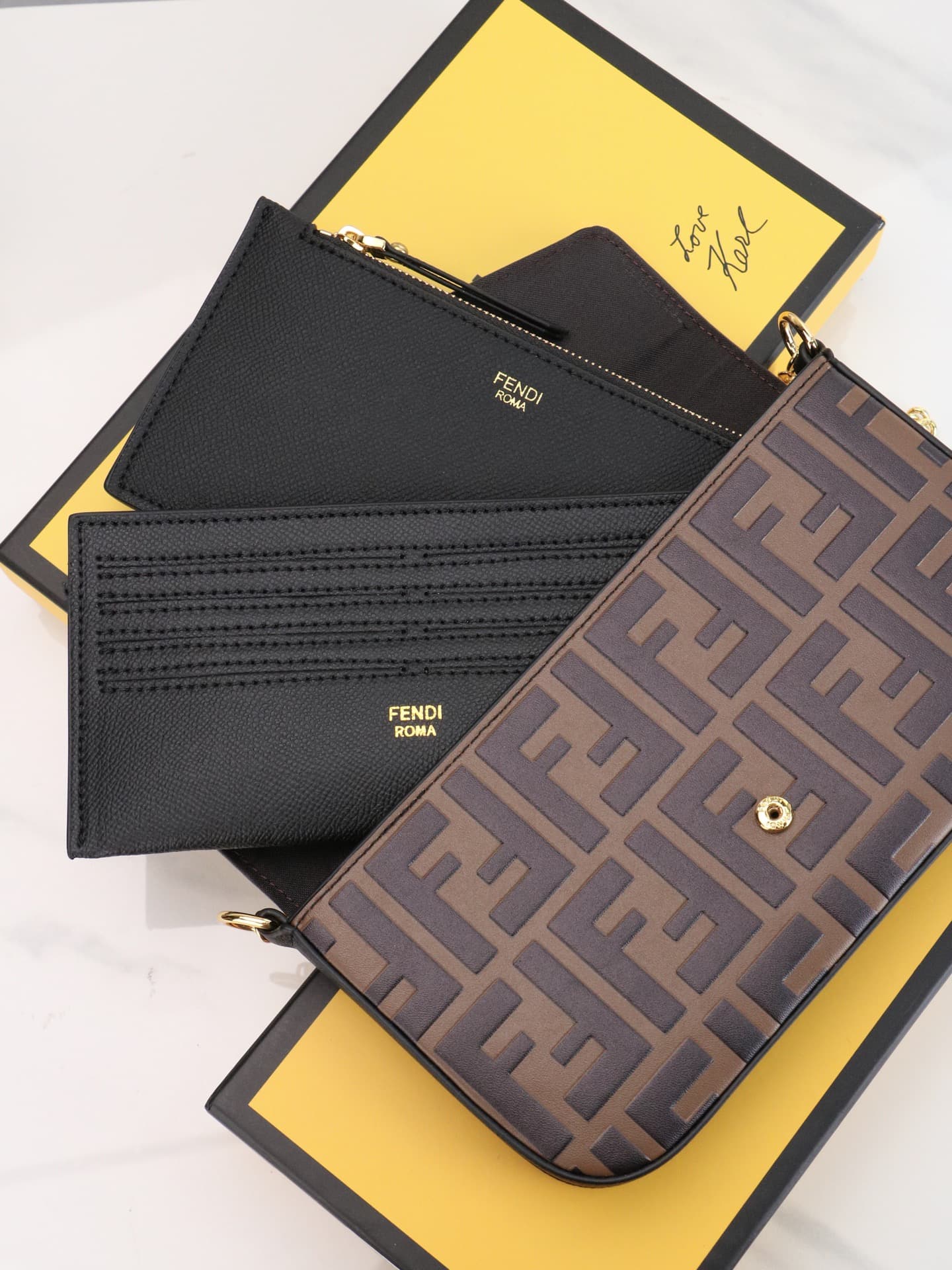 C2869 Fendi mini handbag with geometric pattern flap, equipped with a zipper closure.可拆卸 chain strap. Interior has flat pockets. The bag’s exterior is made of iconic brown leather with black raised FF print; it includes two detachable inner pockets – one  — image 6