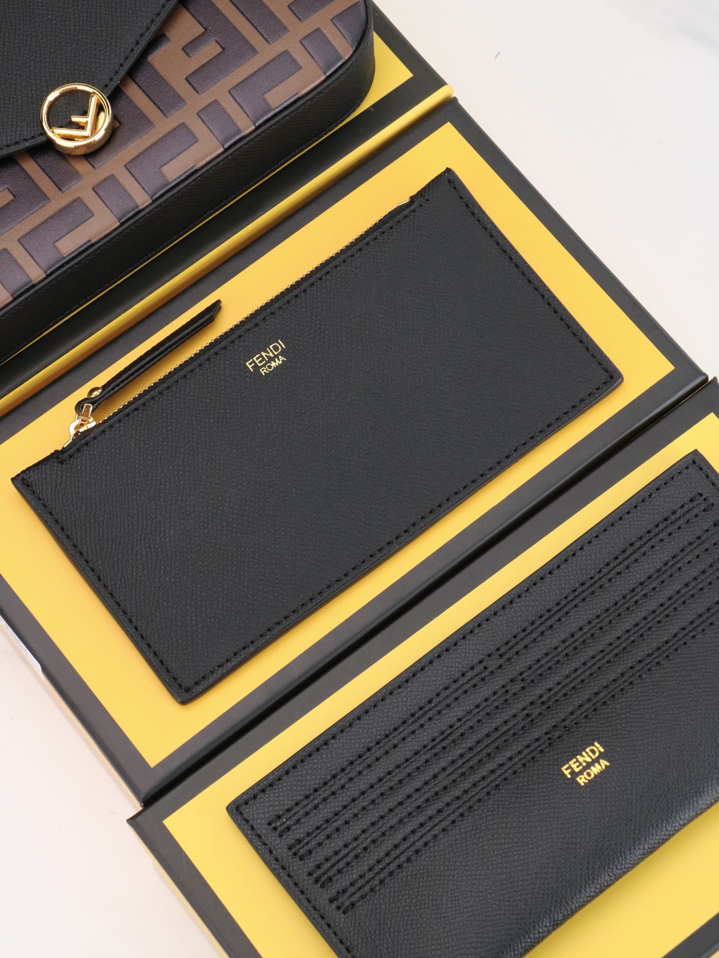C2869 Fendi mini handbag with geometric pattern flap, equipped with a zipper closure.可拆卸 chain strap. Interior has flat pockets. The bag’s exterior is made of iconic brown leather with black raised FF print; it includes two detachable inner pockets – one  — image 7