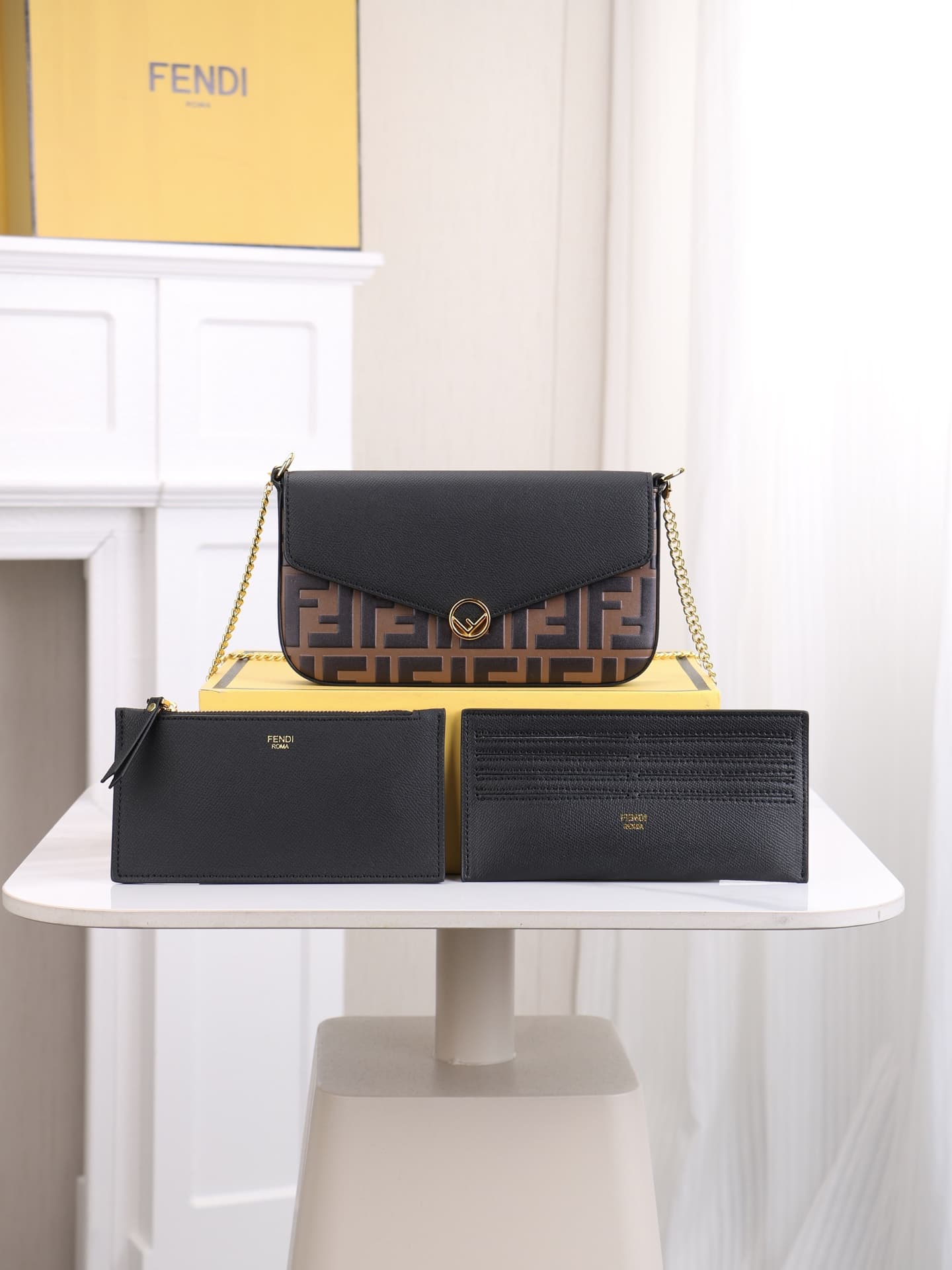 C2869 Fendi mini handbag with geometric pattern flap, equipped with a zipper closure.可拆卸 chain strap. Interior has flat pockets. The bag’s exterior is made of iconic brown leather with black raised FF print; it includes two detachable inner pockets – one  — image 1