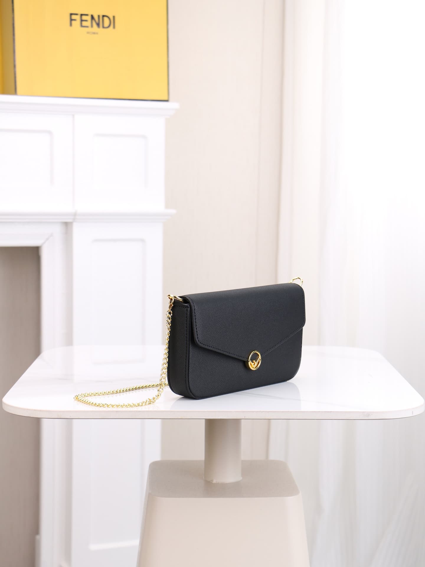 C2868 Fendi mini handbag with geometric pattern snap closures, detachable chain shoulder strap. Inner lining features flat pockets. The bag is made of iconic brown leather with black raised FF print; it comes with two detachable inner pockets – one made o — image 2