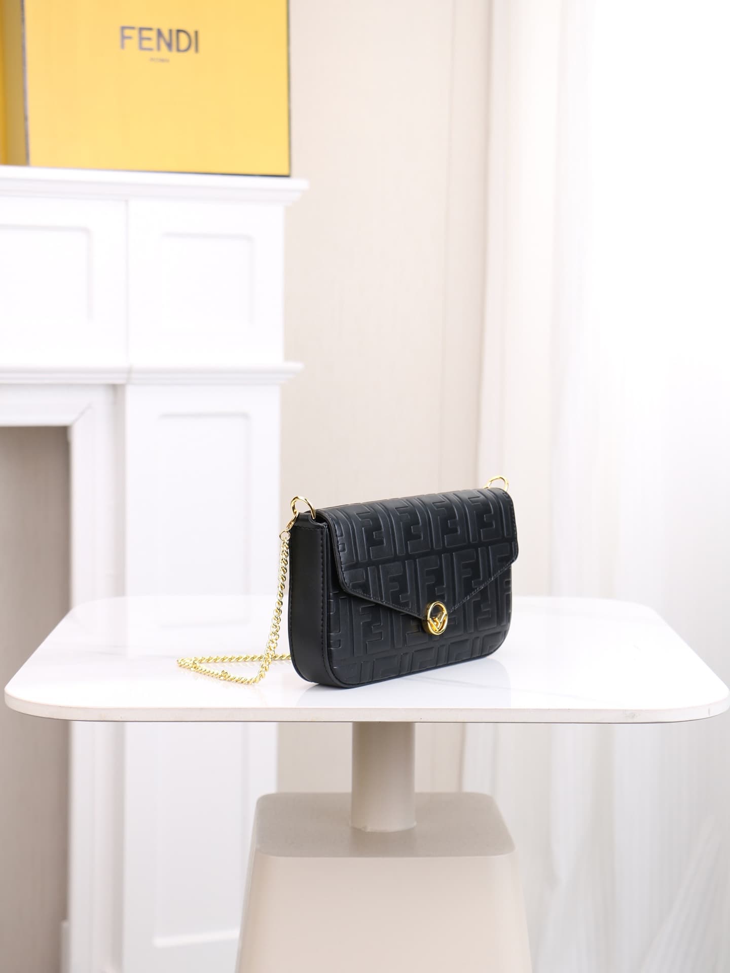 C2867 Fendi mini handbag with geometric pattern snap closure, featuring a detachable chain strap. It has a flat pocket inside. The bag is made of iconic brown leather with black raised FF patterns; it comes with two detachable inner pockets – one made of  — image 2