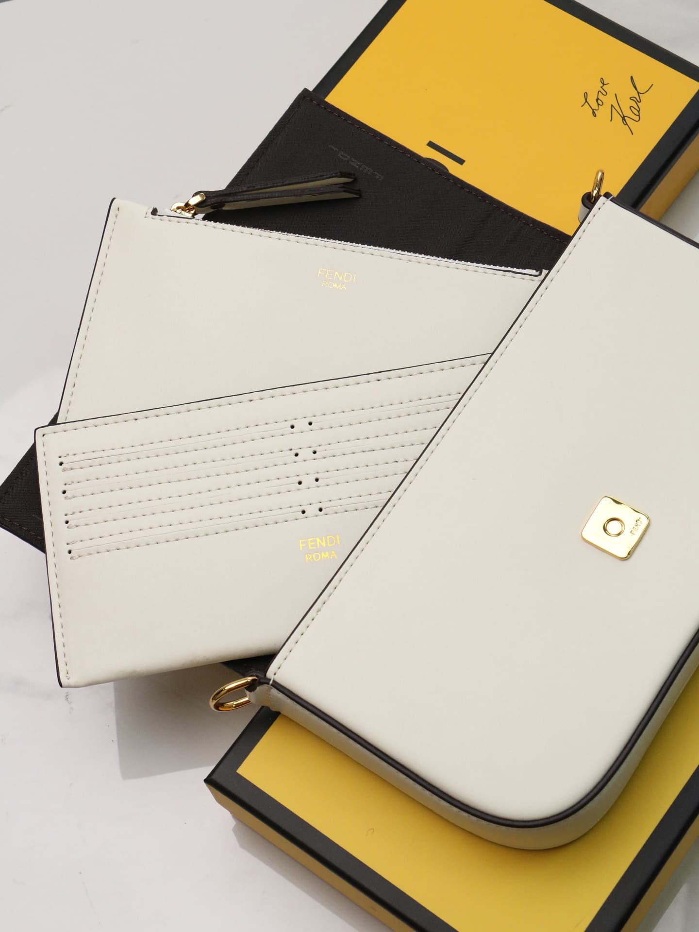 C2866 Fendi mini handbag with geometric patterns, featuring a flip-top closure and snap closures. It has a detachable chain strap. The interior is equipped with flat pockets. The bag’s exterior is made of iconic brown leather with black embossed FF print; — image 7