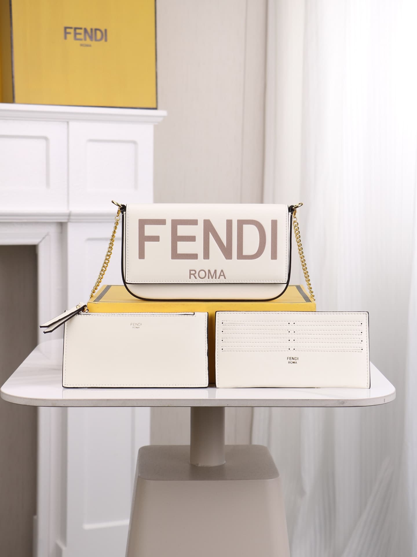C2866 Fendi mini handbag with geometric patterns, featuring a flip-top closure and snap closures. It has a detachable chain strap. The interior is equipped with flat pockets. The bag’s exterior is made of iconic brown leather with black embossed FF print; — image 1