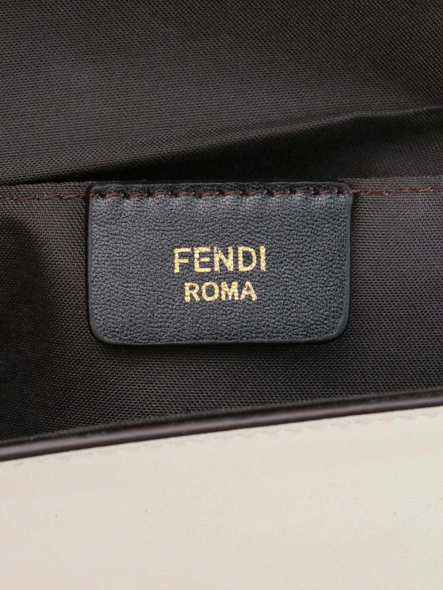 C2866 Fendi mini handbag with geometric patterns, featuring a flip-top closure and snap closures. It has a detachable chain strap. The interior is equipped with flat pockets. The bag’s exterior is made of iconic brown leather with black embossed FF print; — image 8
