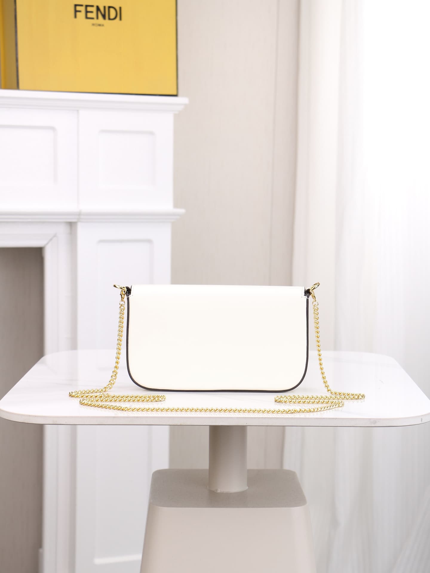 C2866 Fendi mini handbag with geometric patterns, featuring a flip-top closure and snap closures. It has a detachable chain strap. The interior is equipped with flat pockets. The bag’s exterior is made of iconic brown leather with black embossed FF print; — image 4