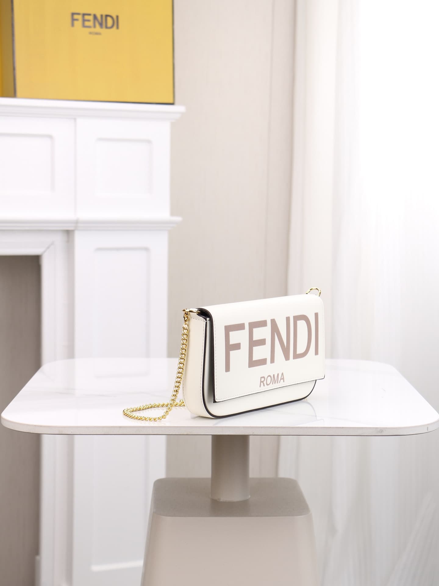 C2866 Fendi mini handbag with geometric patterns, featuring a flip-top closure and snap closures. It has a detachable chain strap. The interior is equipped with flat pockets. The bag’s exterior is made of iconic brown leather with black embossed FF print; — image 2