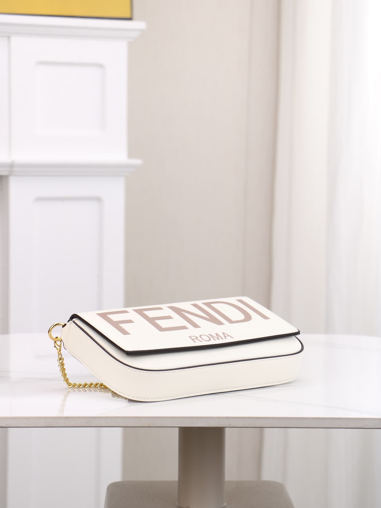 C2866 Fendi mini handbag with geometric patterns, featuring a flip-top closure and snap closures. It has a detachable chain strap. The interior is equipped with flat pockets. The bag’s exterior is made of iconic brown leather with black embossed FF print; — image 3