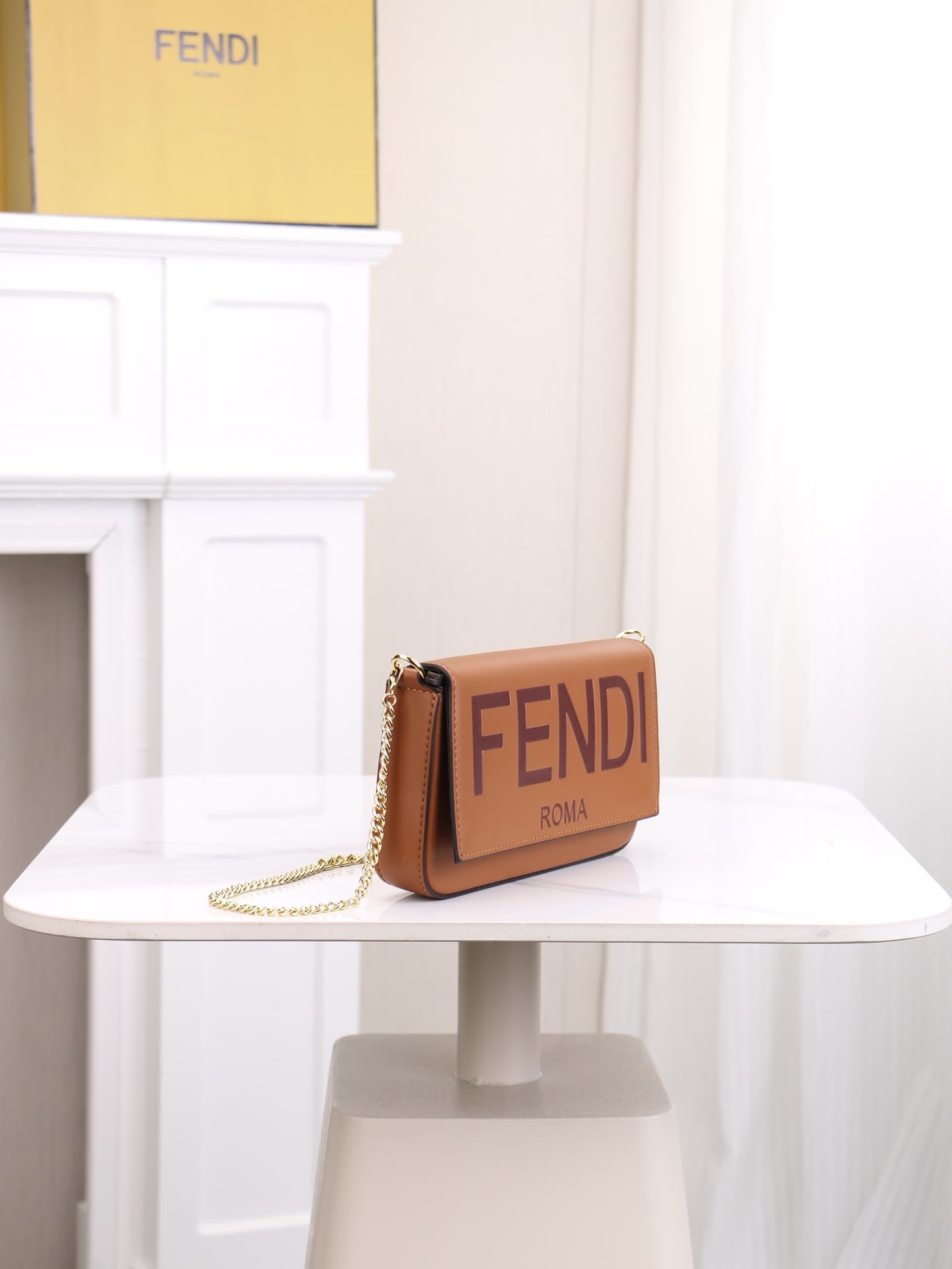 C2865 Fendi mini handbag with geometric pattern flap, featuring a zipper closure. Detachable chain strap. Interior lined with flat pockets. The bag is made of iconic brown leather with black raised FF print; it comes with two detachable inner pockets – on — image 2