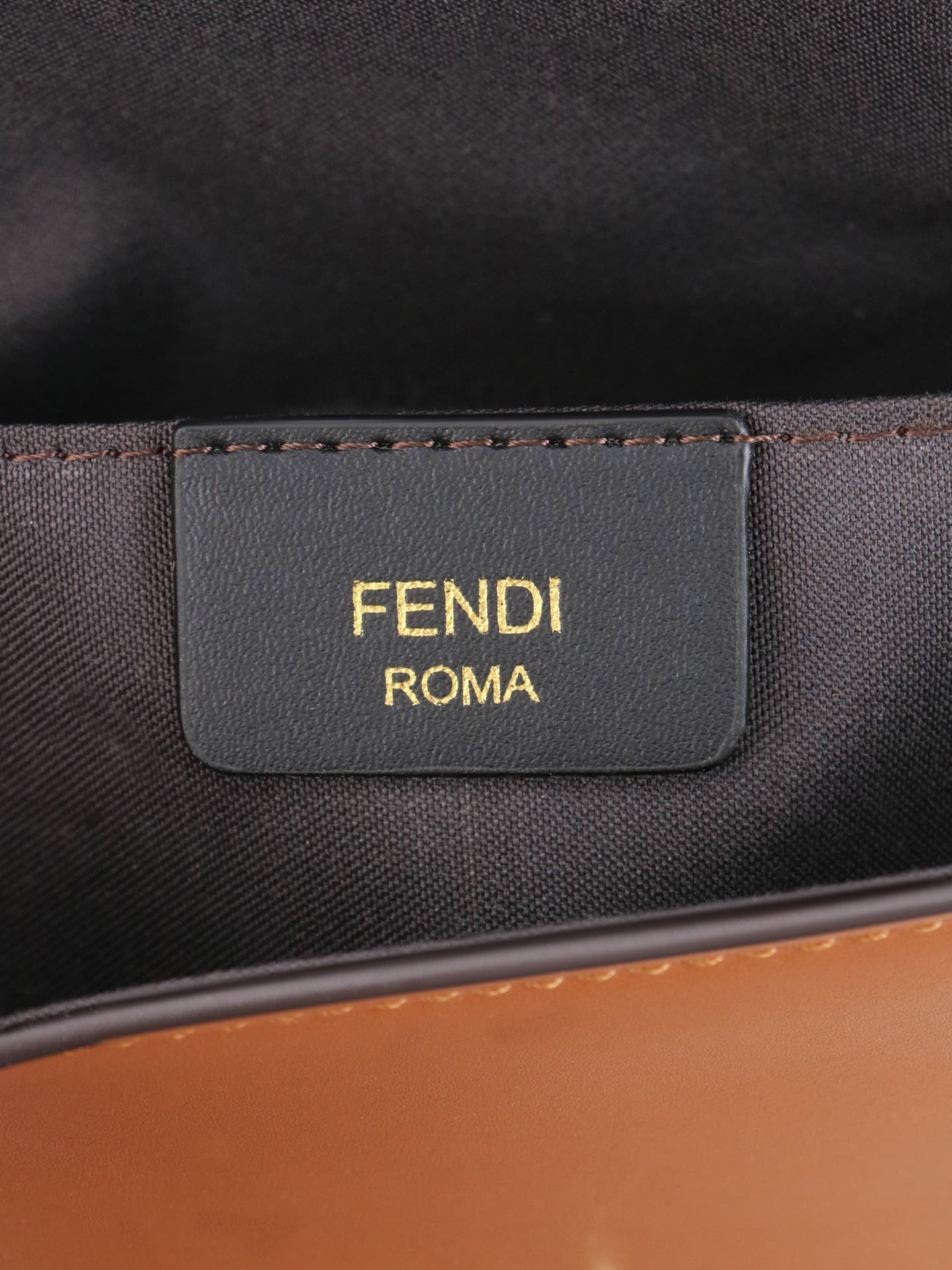 C2865 Fendi mini handbag with geometric pattern flap, featuring a zipper closure. Detachable chain strap. Interior lined with flat pockets. The bag is made of iconic brown leather with black raised FF print; it comes with two detachable inner pockets – on — image 8
