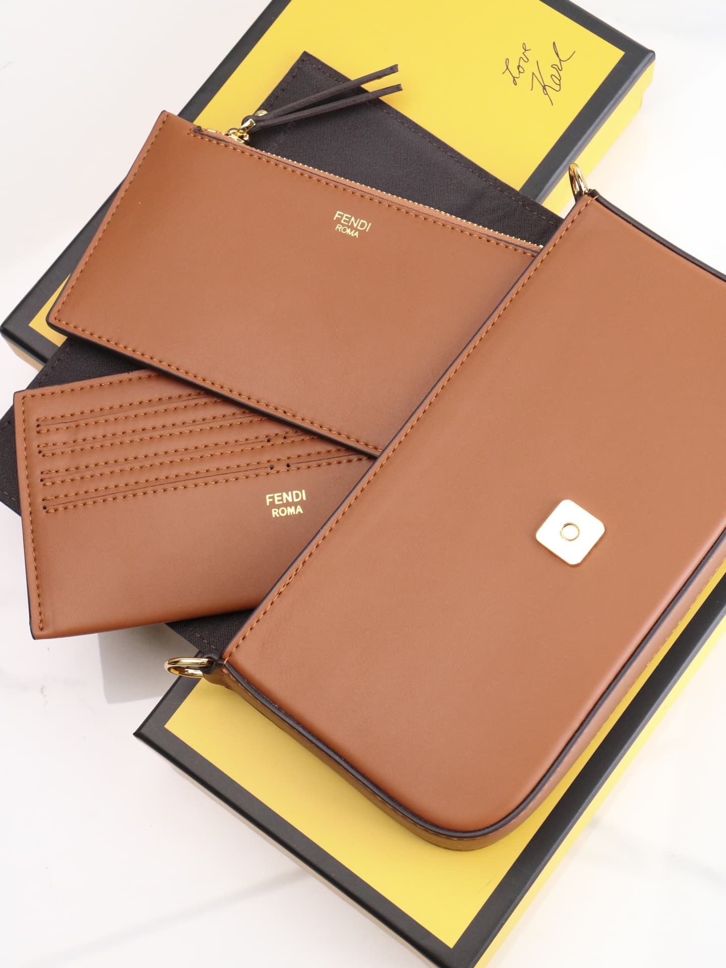 C2865 Fendi mini handbag with geometric pattern flap, featuring a zipper closure. Detachable chain strap. Interior lined with flat pockets. The bag is made of iconic brown leather with black raised FF print; it comes with two detachable inner pockets – on — image 7