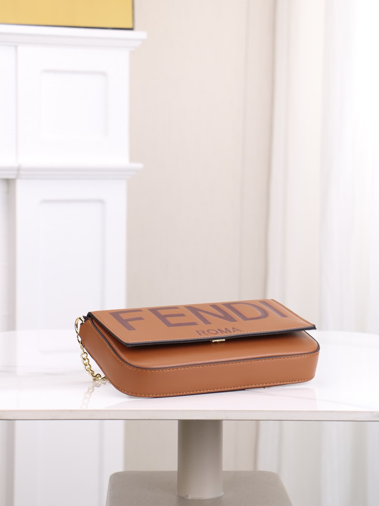C2865 Fendi mini handbag with geometric pattern flap, featuring a zipper closure. Detachable chain strap. Interior lined with flat pockets. The bag is made of iconic brown leather with black raised FF print; it comes with two detachable inner pockets – on — image 3