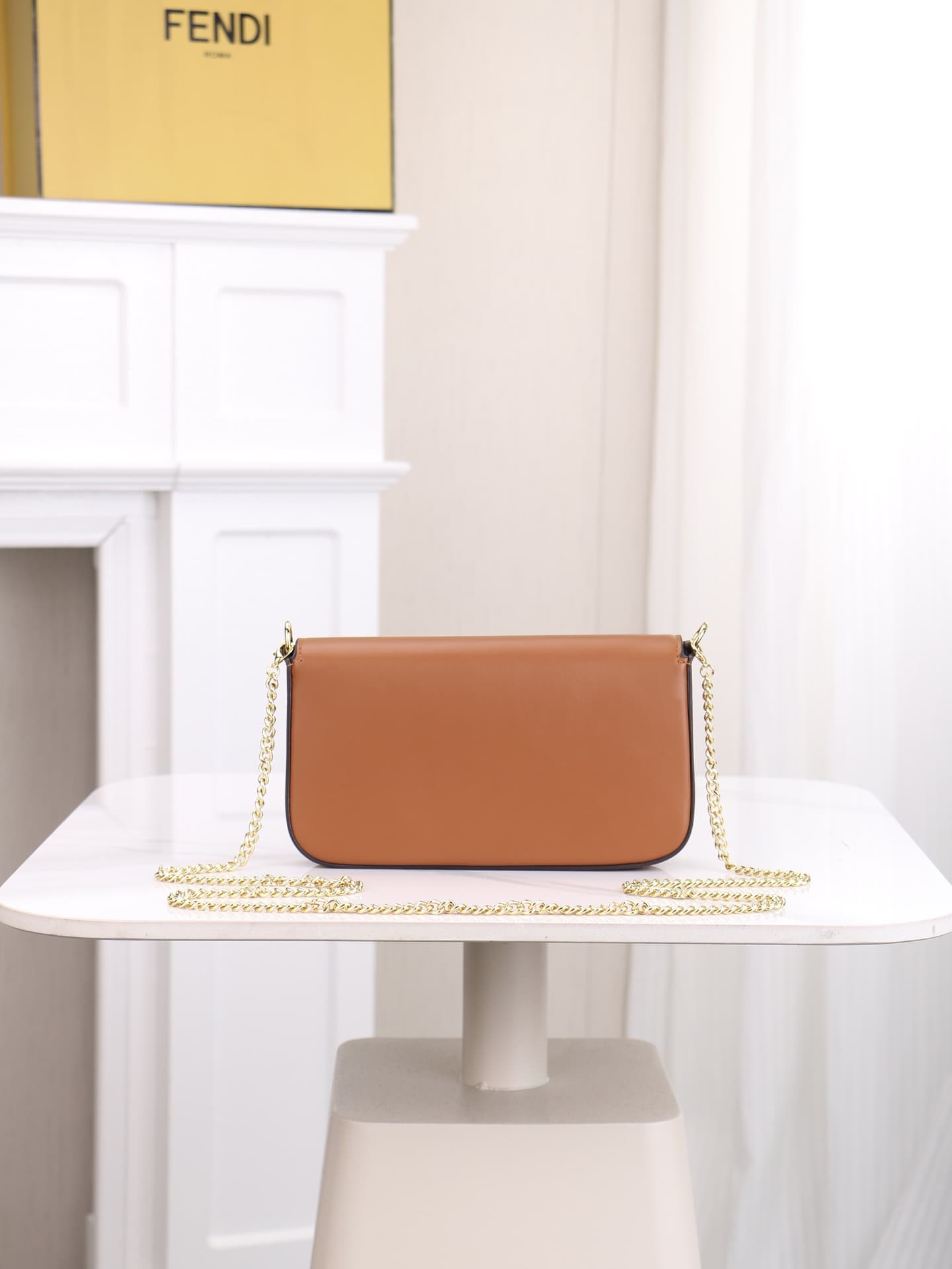 C2865 Fendi mini handbag with geometric pattern flap, featuring a zipper closure. Detachable chain strap. Interior lined with flat pockets. The bag is made of iconic brown leather with black raised FF print; it comes with two detachable inner pockets – on — image 4