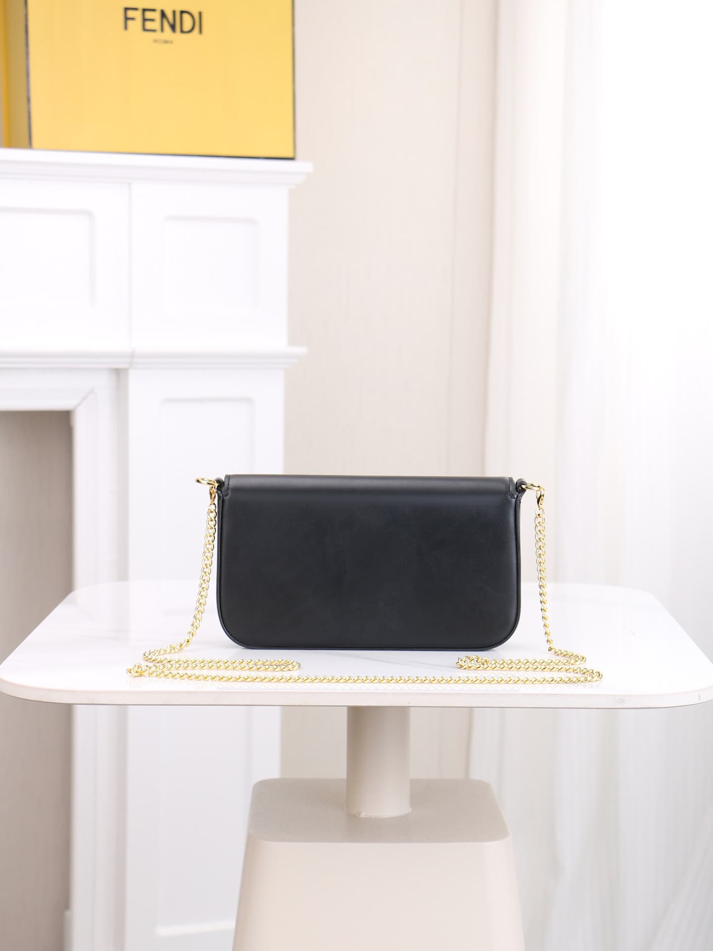 C2864 Fendi mini handbag with geometric pattern flap, equipped with zipper closure. Removable chain shoulder strap. Inner lining features flat pockets. The bag’s exterior is made of iconic brown leather with black raised FF print patterns. It includes two — image 4